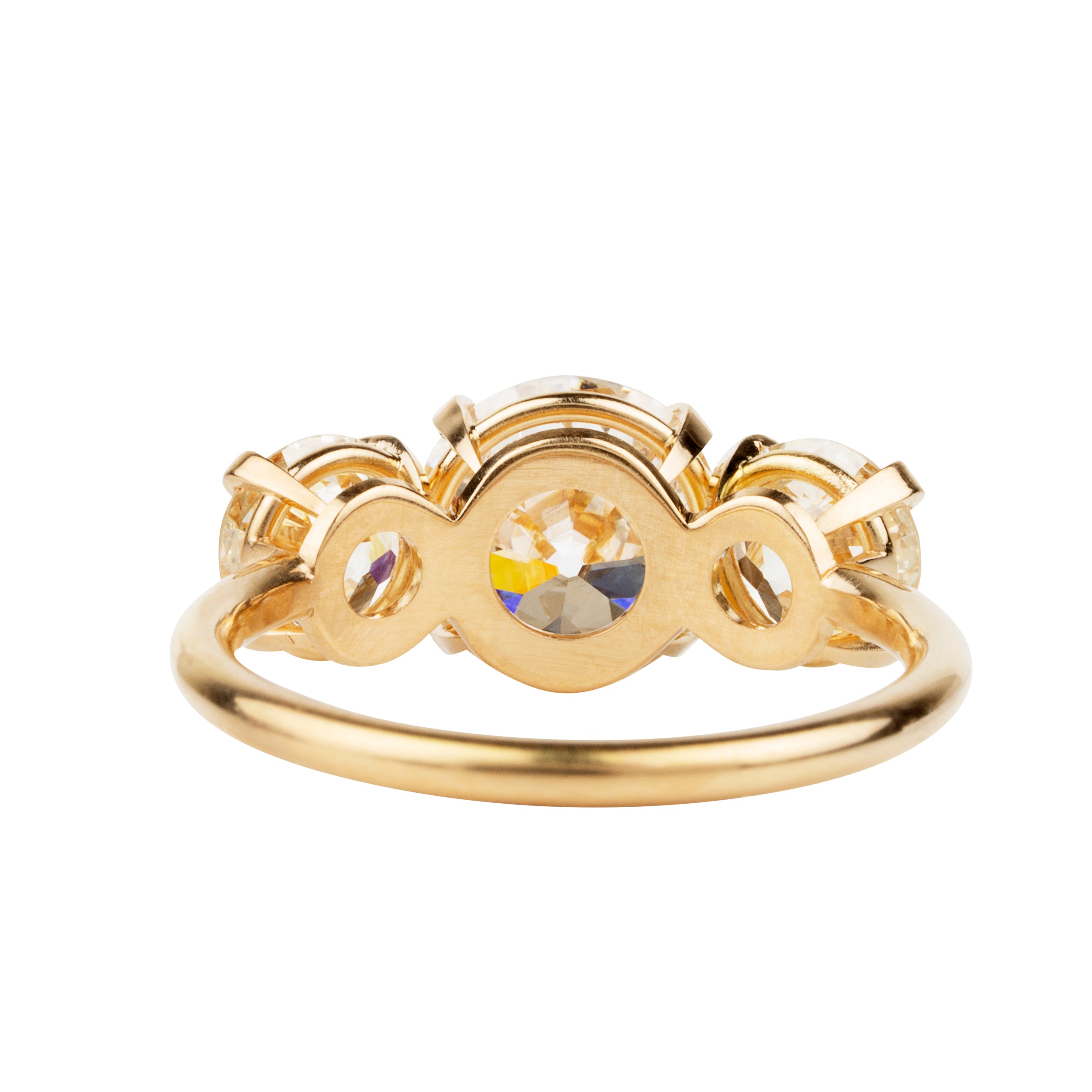 A classic three-stone diamond ring in our 18k old gold featuring a slim band. The center stone is set with four tab prongs. This example features three old European cut diamonds. The center stone in this example is 1.93-carat diamond, GIA-certified H color, and VS1 clarity. Flanked by 2 old European cut diamond side stones, 0.85 carats and 0.76 carats J Color/ VS1 clarity.