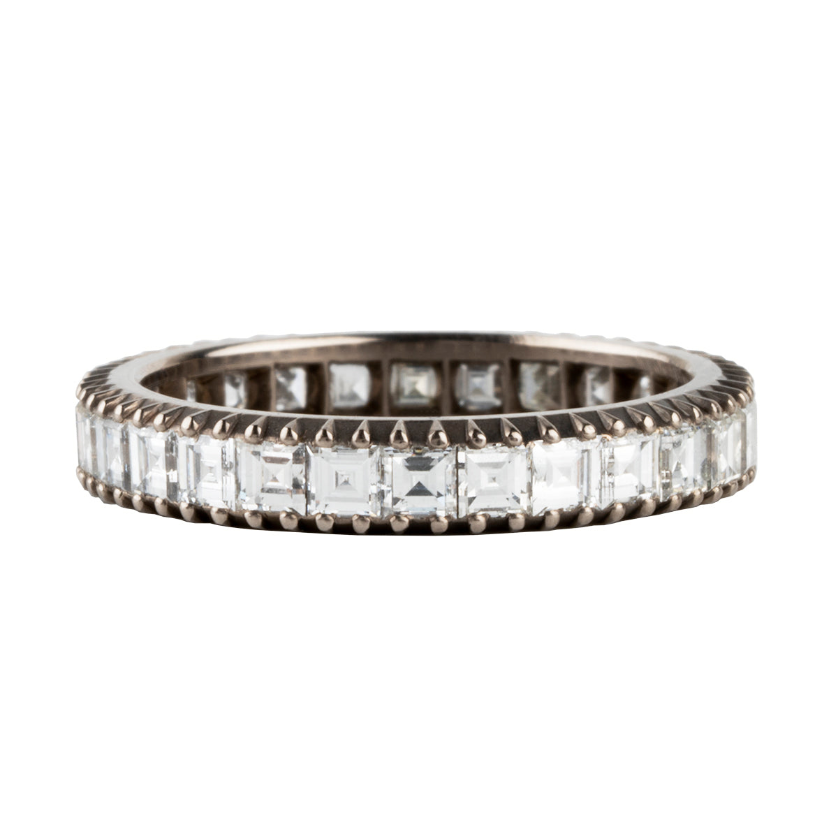 Handmade diamond eternity band set with carré cut diamonds. It is inspired by the labor intensive setting technique of many 18th and 19th century rings we have encountered over the years. Made in our 18k palladium white gold. Size 6.75 has approximately 1.96 carats, G-H/VS.