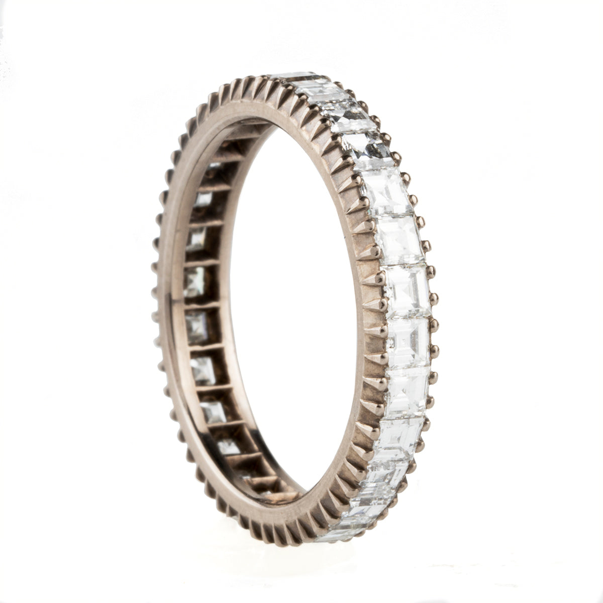 Handmade diamond eternity band set with carré cut diamonds. It is inspired by the labor intensive setting technique of many 18th and 19th century rings we have encountered over the years. Made in our 18k palladium white gold. Size 6.75 has approximately 1.96 carats, G-H/VS.