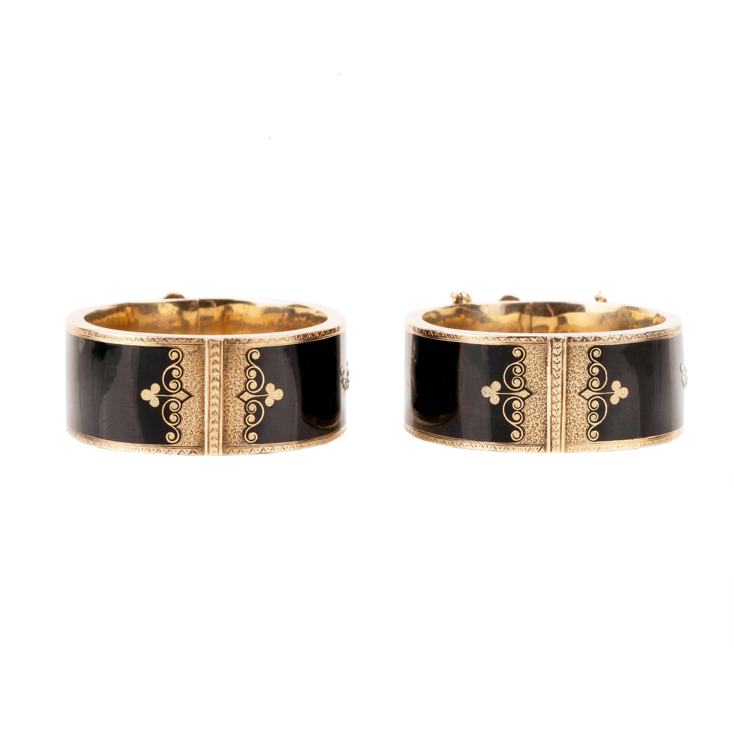 In the 19th century, the Lilly of the Valley flower was a common mourning motif that symbolized a return to happiness. This is a nicely preserved set of 14k gold bracelets with black enamel, pearls and delicate engraving. They are small in size, measuring 5.25 inches in circumference. American, circa 1870. Side view.