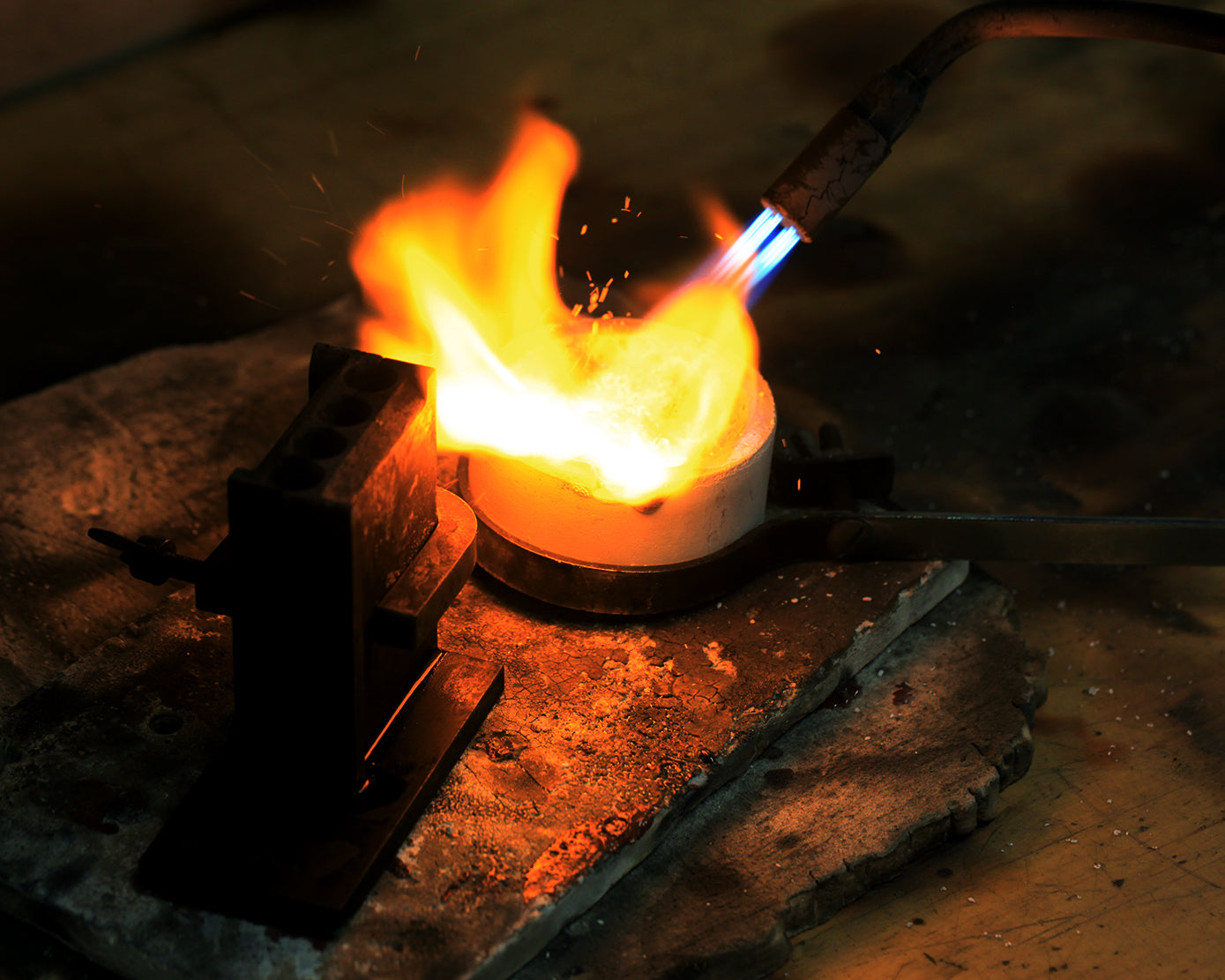 Photo of our jewelers making an ingot of gold
