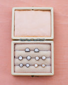 View of a collection of cutaway Bell & Bird Diamond Earrings