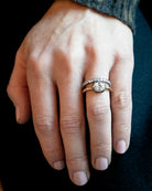 One of our signature designs, in silver-topped 18k gold. This design s inspired by a labor-intensive setting technique common in 18th and 19th-century rings. The silver-on-gold technique is true to the rings that inspired this design and is rarely seen in modern jewelry. This features a GIA certified cushion cut diamond 1.43 carat, I color and VS2 clarity. The ring being modeled on a hand.