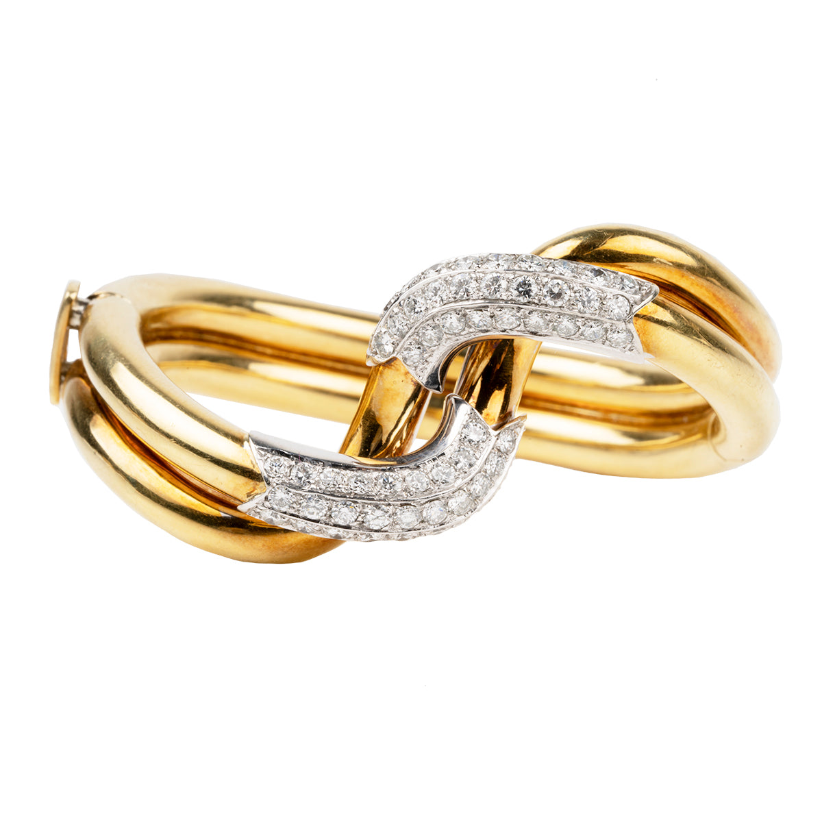 Finely crafted bangle in 18k gold and platinum set with 56 diamonds, approximated total weight 2.5 carats.American in origin. Circa 1970. Front View.