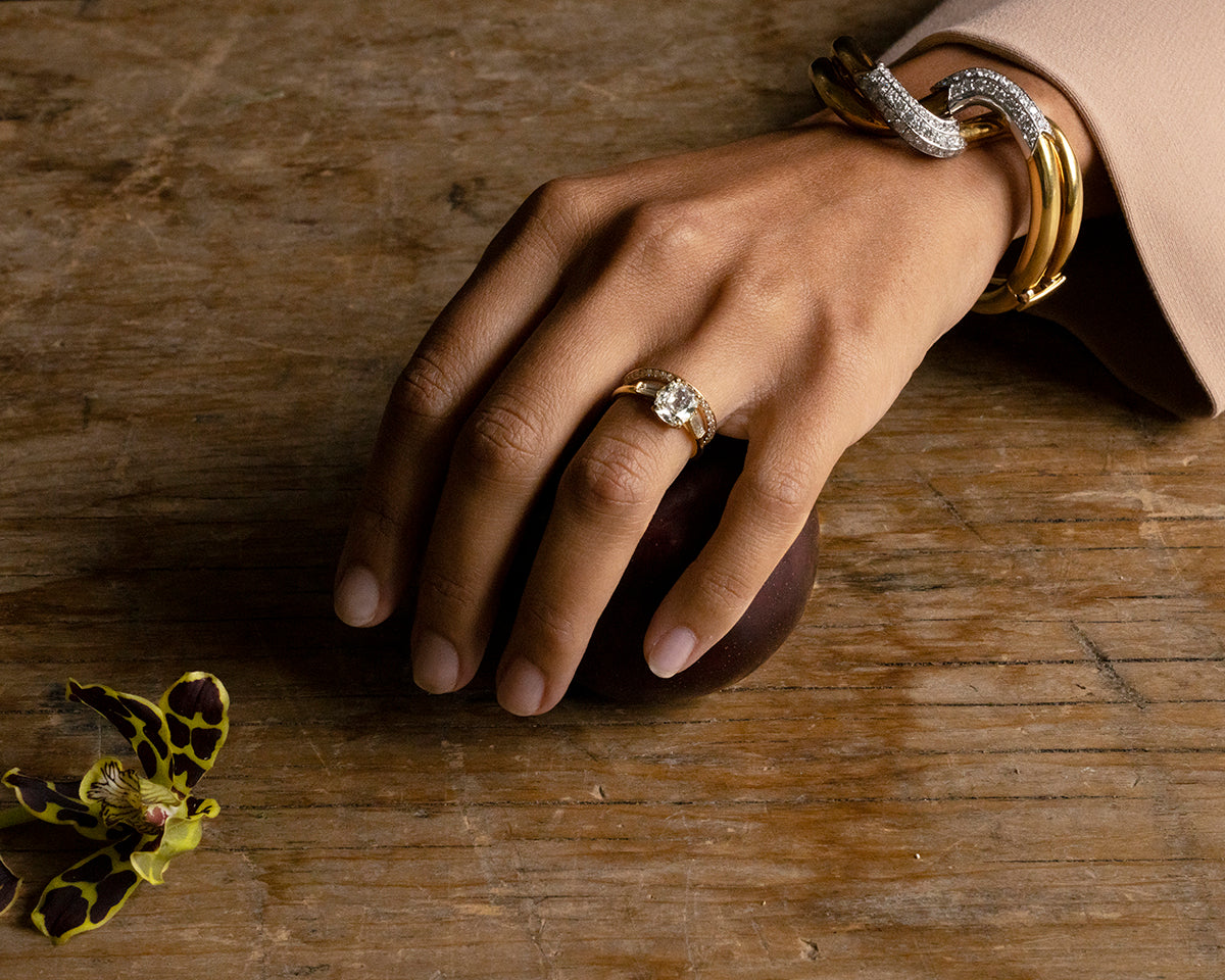 Finely crafted bangle in 18k gold and platinum set with 56 diamonds, approximated total weight 2.5 carats.American in origin. Circa 1970. On a model.