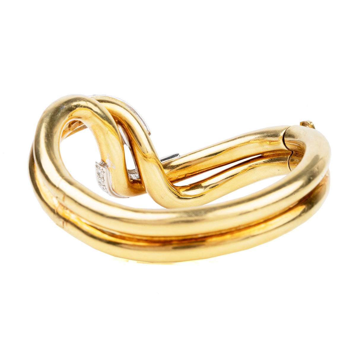 Finely crafted bangle in 18k gold and platinum set with 56 diamonds, approximated total weight 2.5 carats.American in origin. Circa 1970. Back bracelet.
