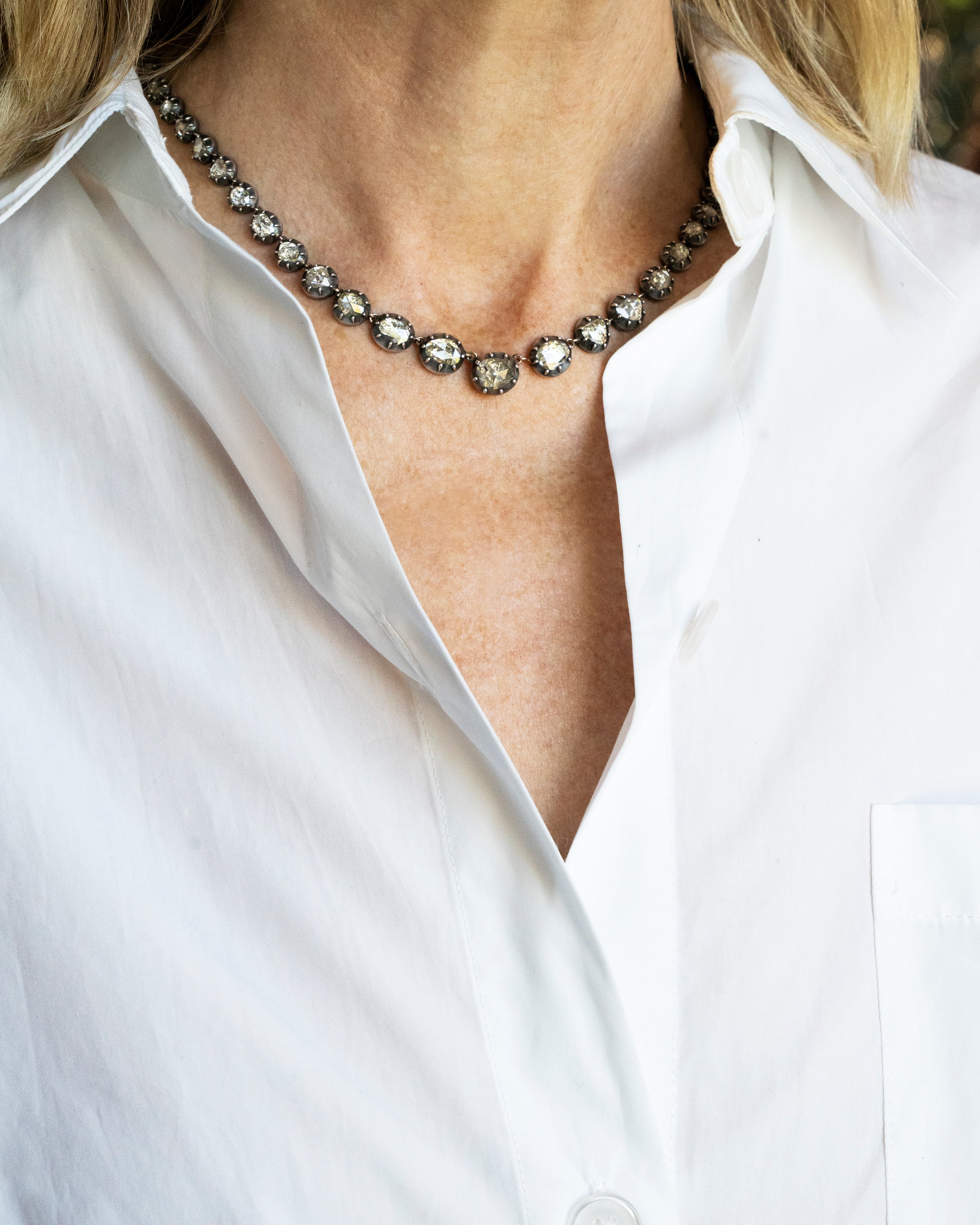 Georgian Era Rose Cut Diamond Rivière Necklace. Being model on a neck along with a white collared shirt.