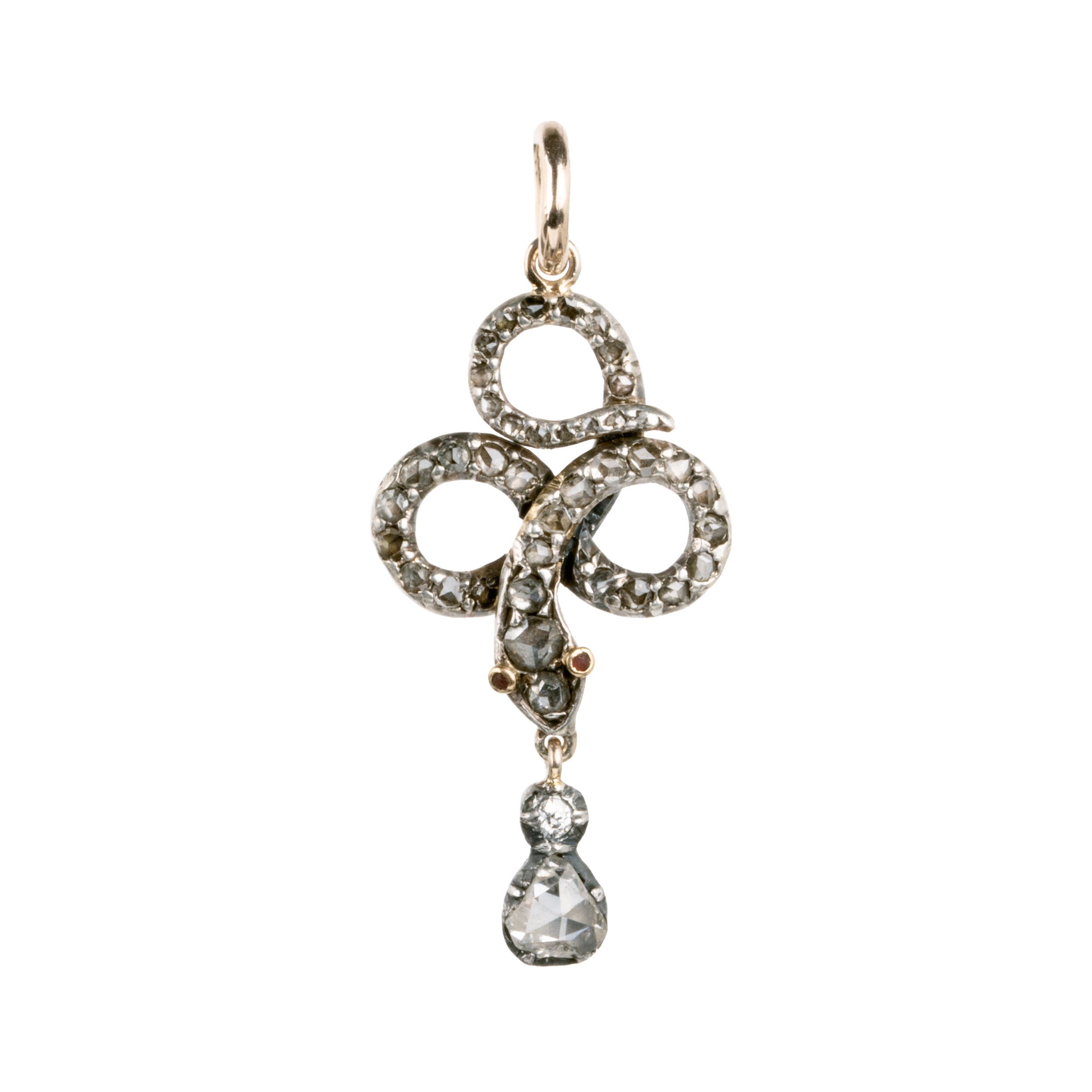 Rose cut diamonds are set  in silver topped gold in the form of a snake. The snake is coiled into a trefoil design with a tear drop shaped diamond drop. The detail extends to two tiny ruby eyes. The piece appears to have been converted into a pendant from a brooch or stick pin. England, Circa 1820. Close up front view.