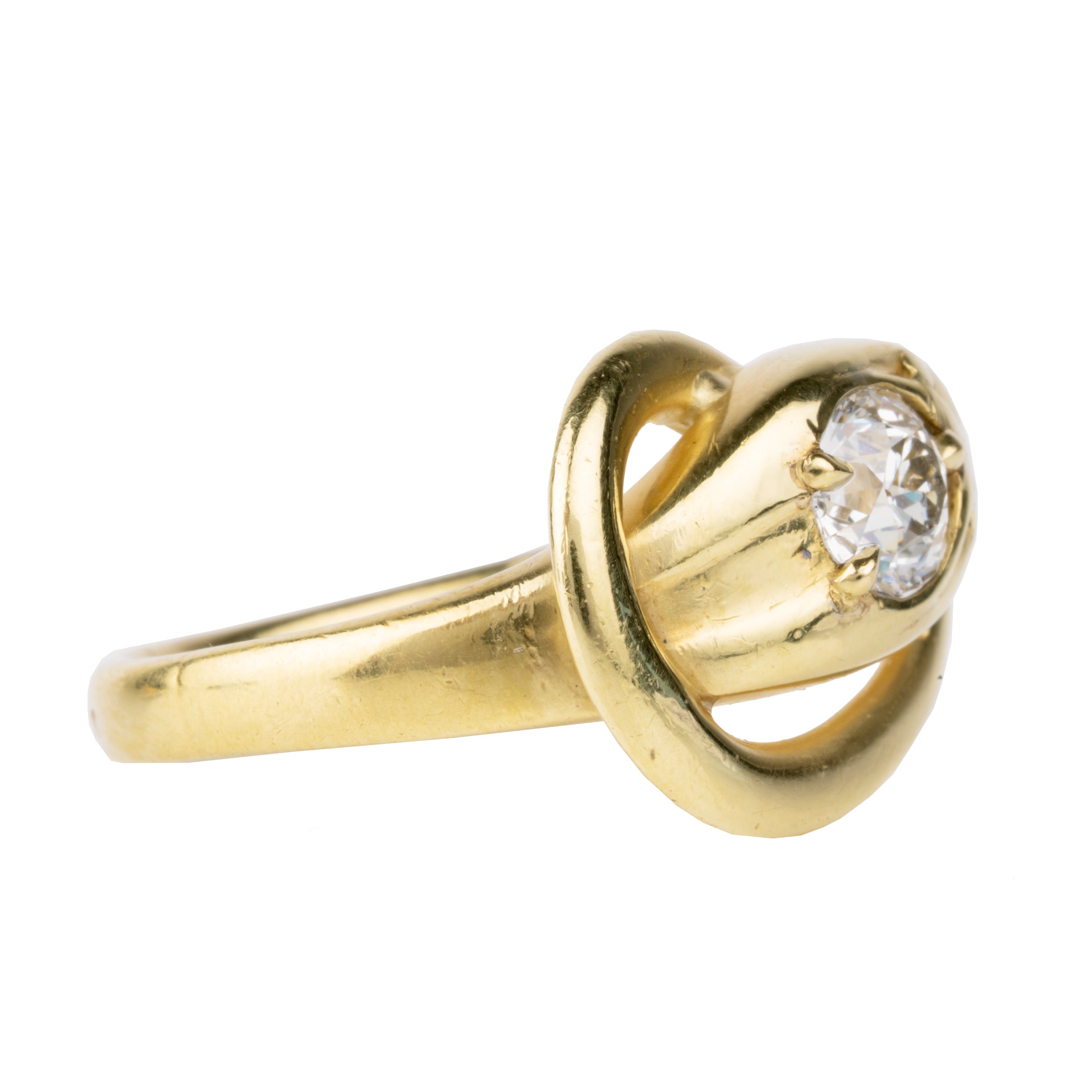 Victorian era diamond snake ring in 18k gold. An approximately 0.80 carat antique old European cut diamond in the head. English in origin. Circa 1890. Side view.