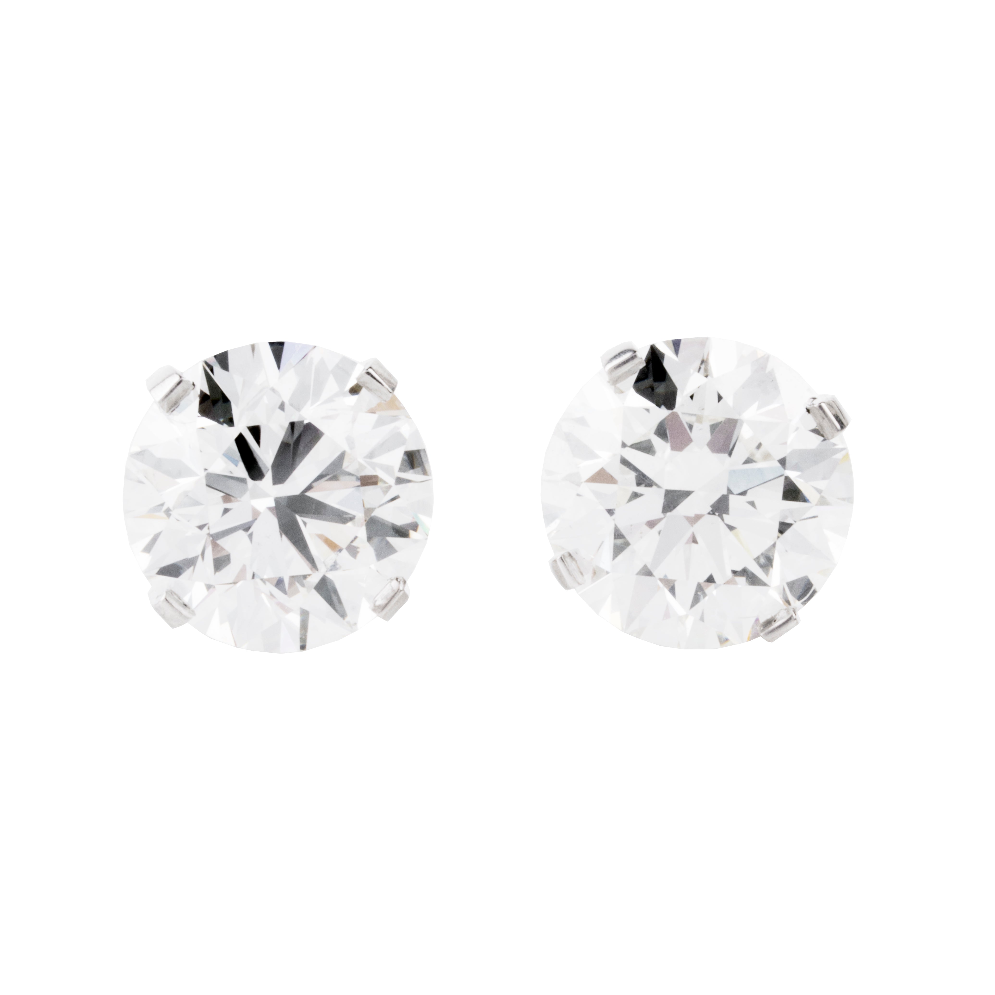 Classic round brilliant cut diamond earring studs. Handmade platinum four-tab prong settings with locking backs. Featuring two GIA certified diamonds, 2.01 carats J color and SI1 clarity and 2.01 I color and SI1 clarity. Over four carats in total weight. Front view of the diamond earrings.