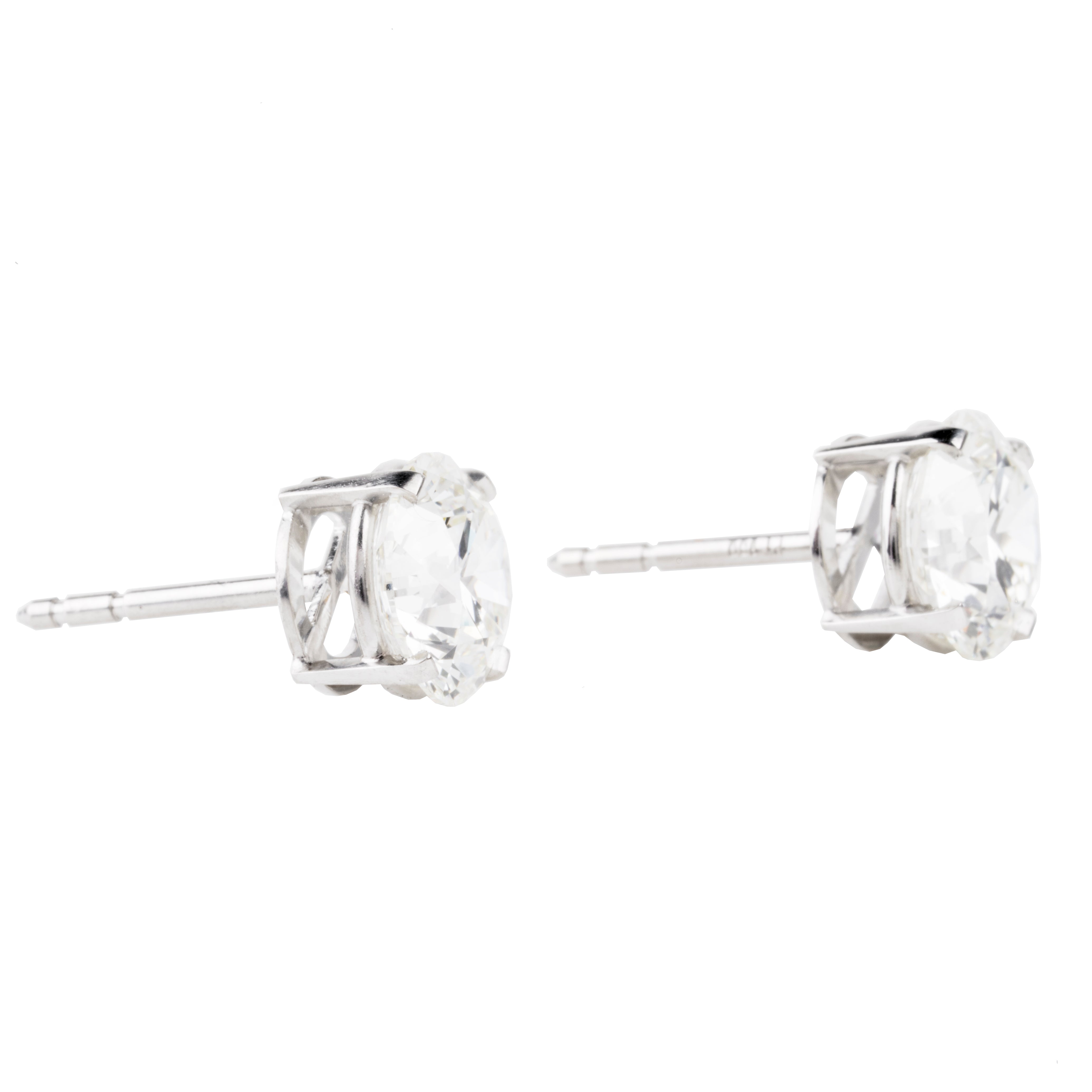 Classic round brilliant cut diamond earring studs. Handmade platinum four-tab prong settings with locking backs. Featuring two GIA certified diamonds, 2.01 carats J color and SI1 clarity and 2.01 I color and SI1 clarity. Over four carats in total weight. Front view of the diamond earrings. side view.
