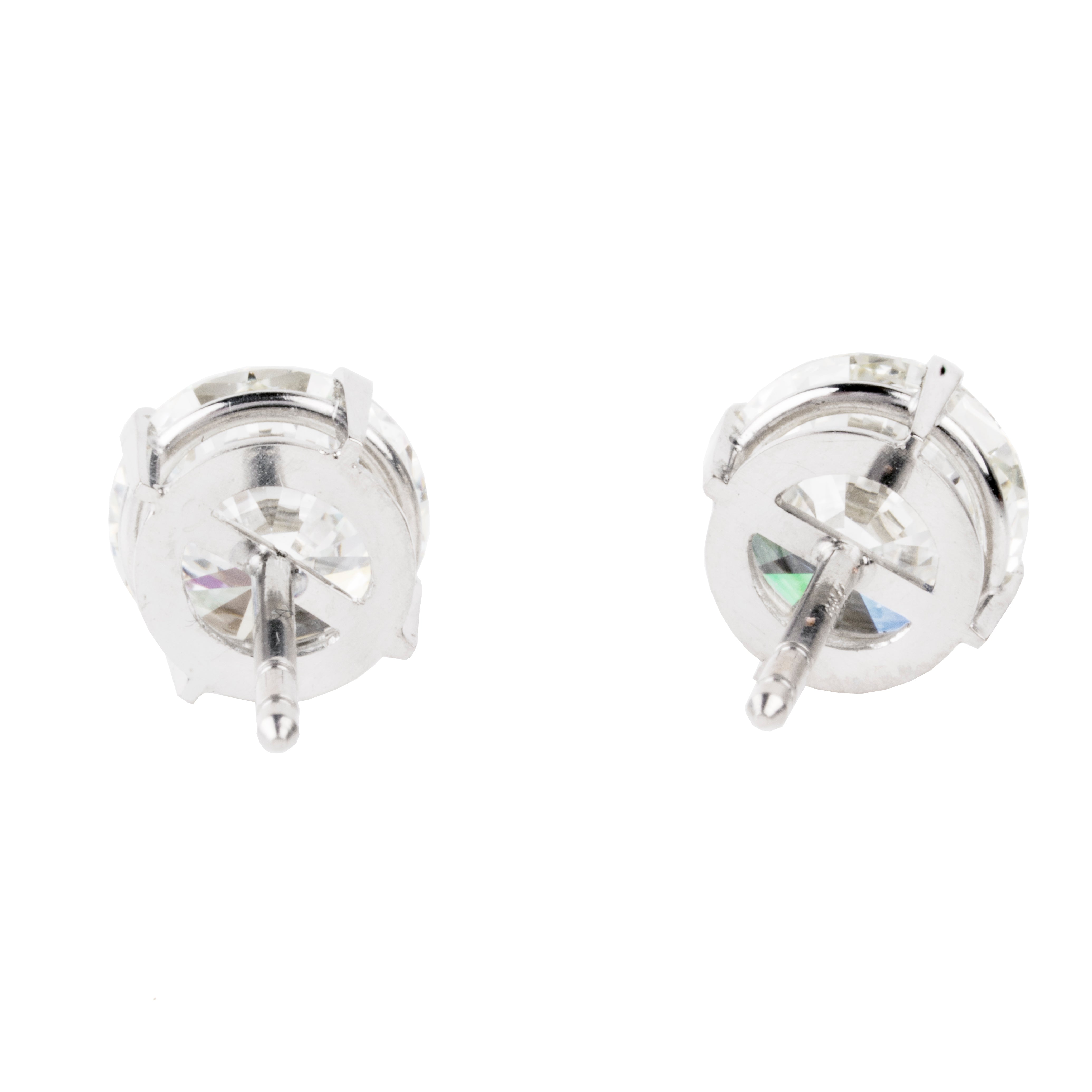 Classic round brilliant cut diamond earring studs. Handmade platinum four-tab prong settings with locking backs. Featuring two GIA certified diamonds, 2.01 carats J color and SI1 clarity and 2.01 I color and SI1 clarity. Over four carats in total weight. Front view of the diamond earrings. Back side view.