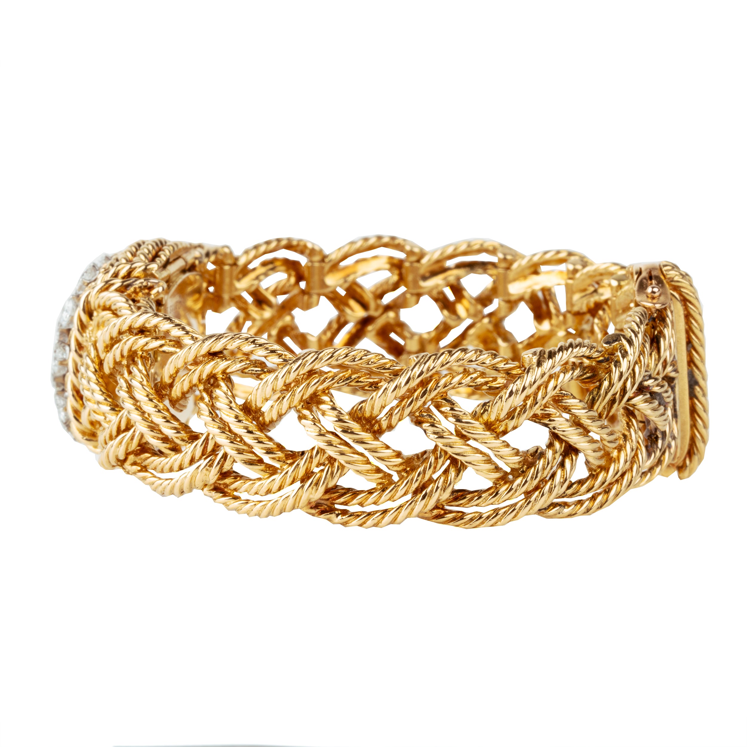 A braided 18k gold bracelet with a diamond panel that opens to reveal a diminutive watch face. The bracelet has an estimated diamond weight of 1.7 carats. Signed Boucheron, Paris. France, circa 1950.