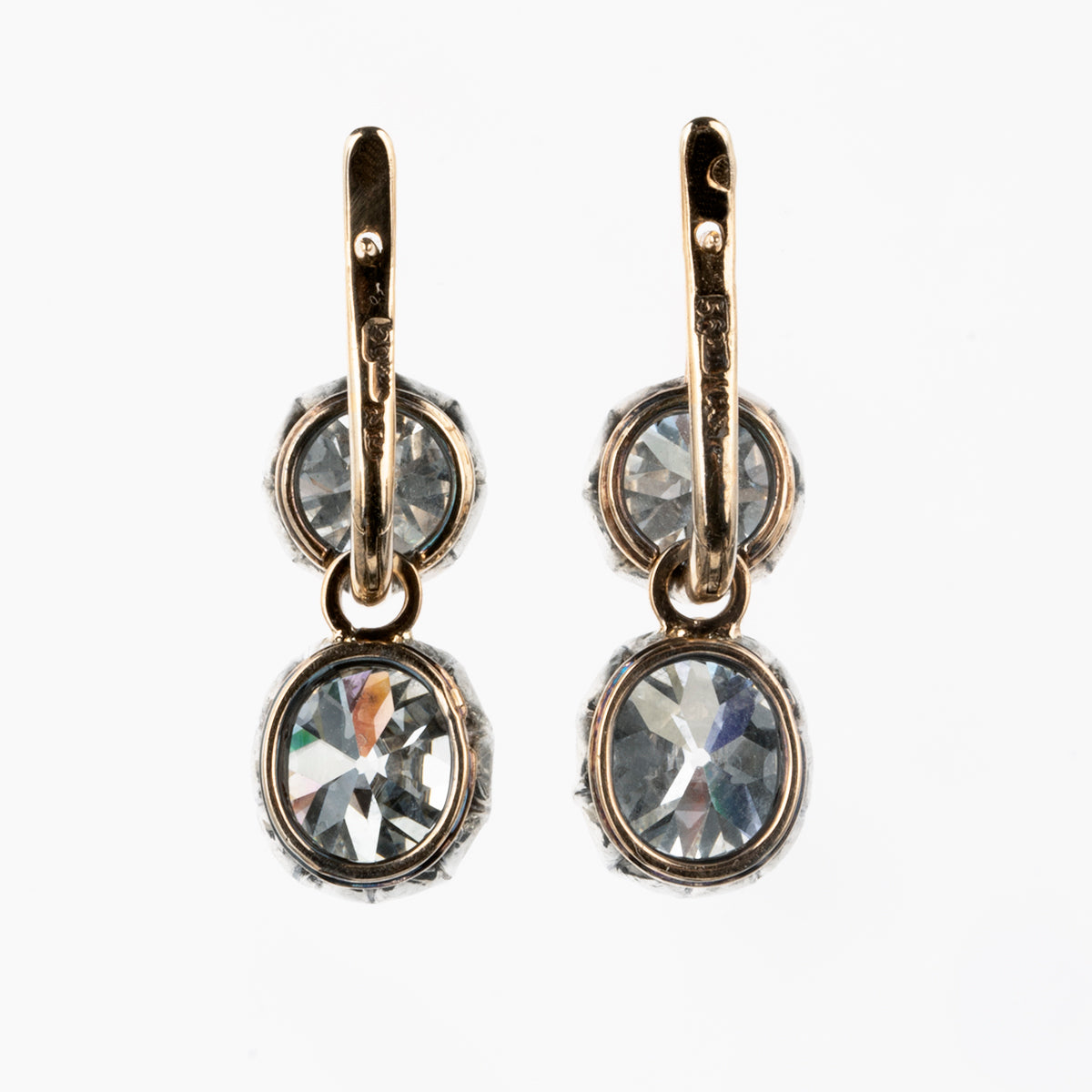 These earrings have an estimated nine carats in total weight. 4 cushion shaped, old mine cut diamonds are set in 14k gold and silver. The settings are arranged to allow a day-to-night function. The two smaller stones can be worn alone or with the larger drops. The smaller stones, weigh approx. 3 carats together. The two larger stones are certified by a French laboratory to be 2.87 carats, L color, and VS1 clarity and 2.96 carats, K color, VS1 clarity. European and French makers marks. back view.