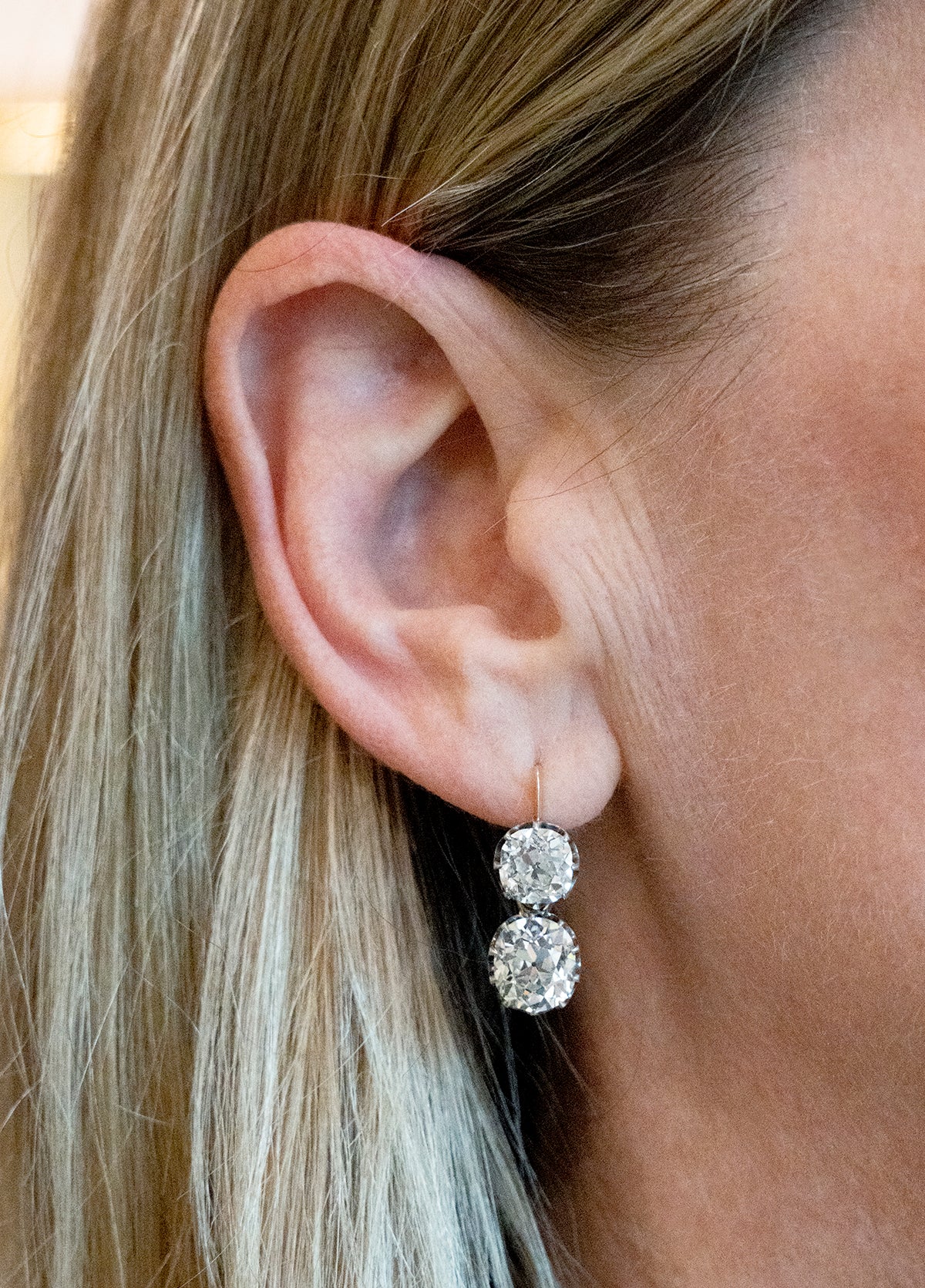 These earrings have an estimated nine carats in total weight. 4 cushion shaped, old mine cut diamonds are set in 14k gold and silver. The settings are arranged to allow a day-to-night function. The two smaller stones can be worn alone or with the larger drops. The smaller stones, weigh approx. 3 carats together. The two larger stones are certified by a French laboratory to be 2.87 carats, L color, and VS1 clarity and 2.96 carats, K color, VS1 clarity. European and French makers marks. Being worn by a model