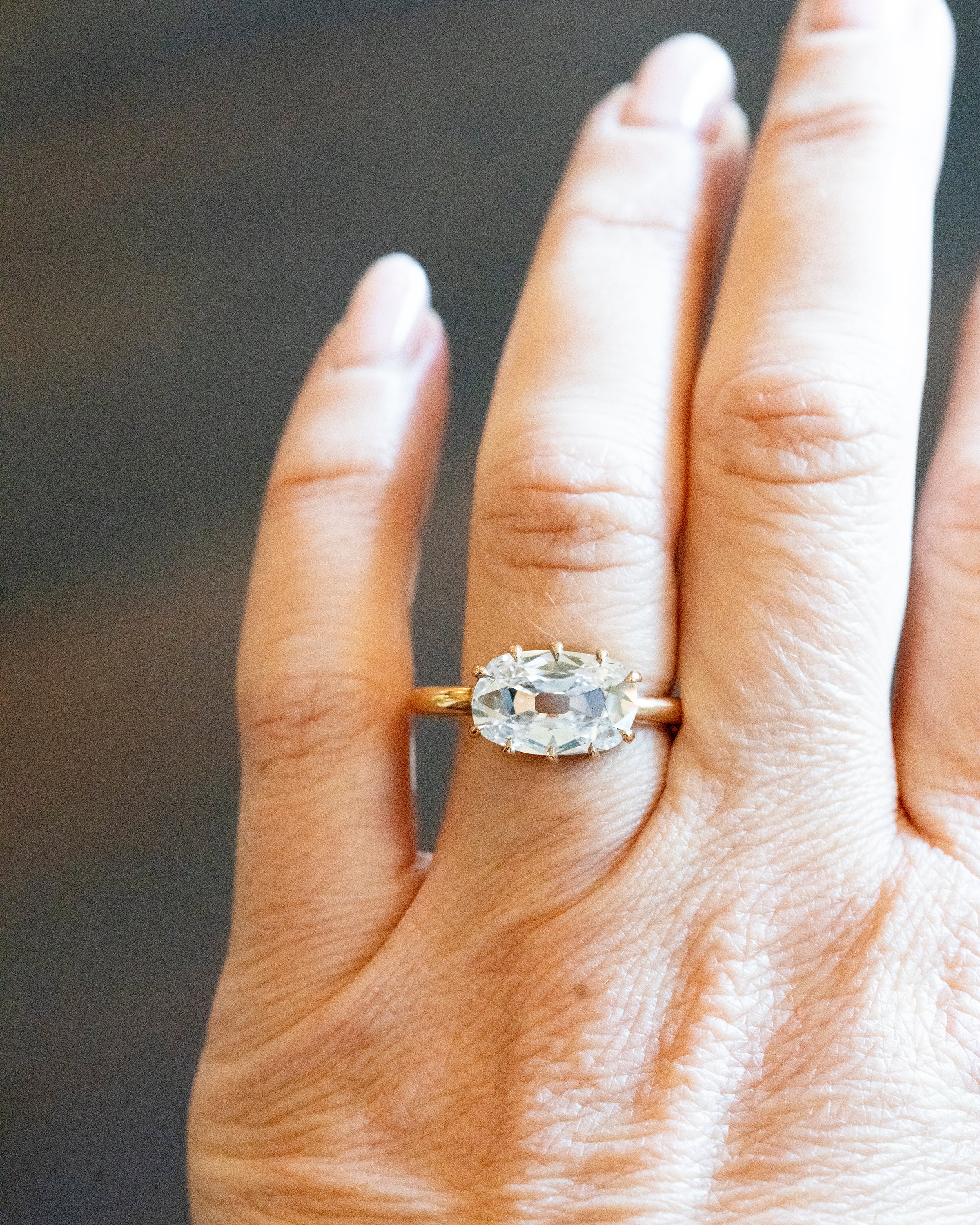 This ring features an unusual antique stone. GIA certified 3.06-carat antique elongated cushion cut diamond, E color, and SI2 clarity. The stone is presented in our handmade 'travel mount' setting in our 18k old gold.