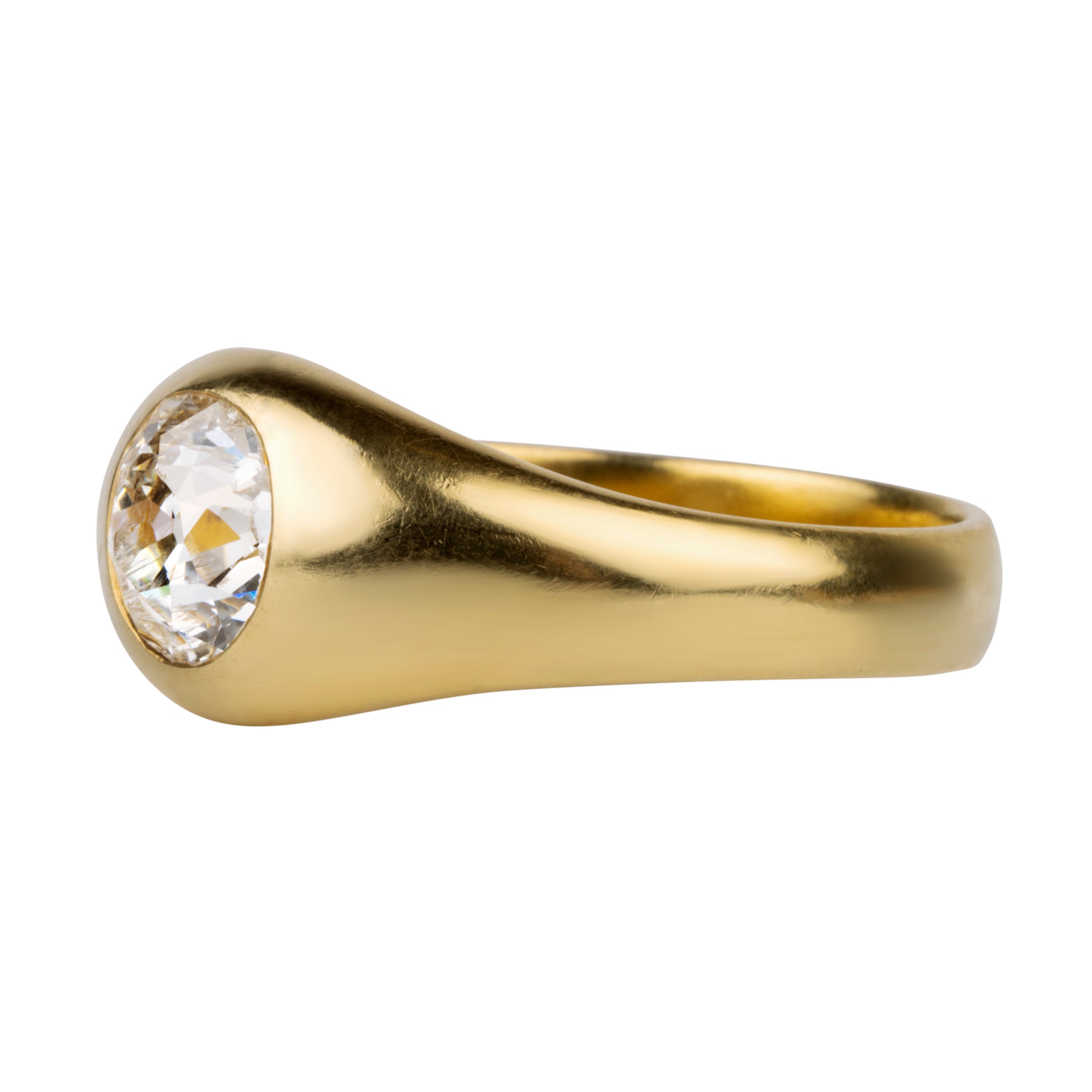 Victorian era flush set diamond solitaire ring. A lovely heavy 18k yellow gold with a single old mine cut diamond approx 1.25 cts, H color. American in origin. Circa 1890. Side view.