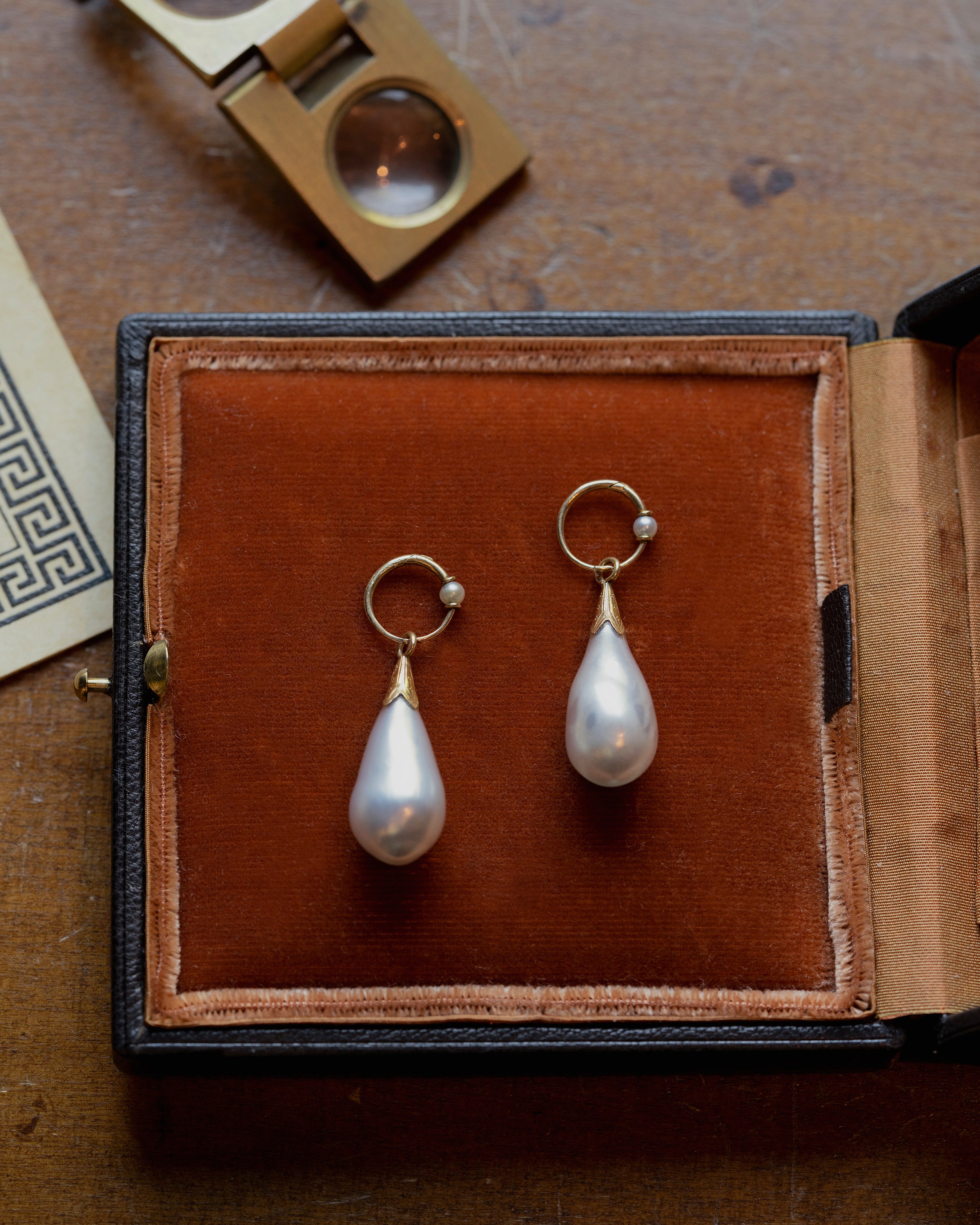 In the 18th century, glass pearl earrings were a popular alternative to natural pearls, and they commanded great prices. These imitation pearls were made by coating the interior of blown glass with a pearlescent ‘nacre’ derived from fish scales and gelatin. Earrings of the time reflected the Baroque and Rococo fashion, favoring long, dangling styles like girandole and pendant earrings. They were a staple in 18th-century jewelry, but their delicate nature makes them very rare today. England. Circa 1870