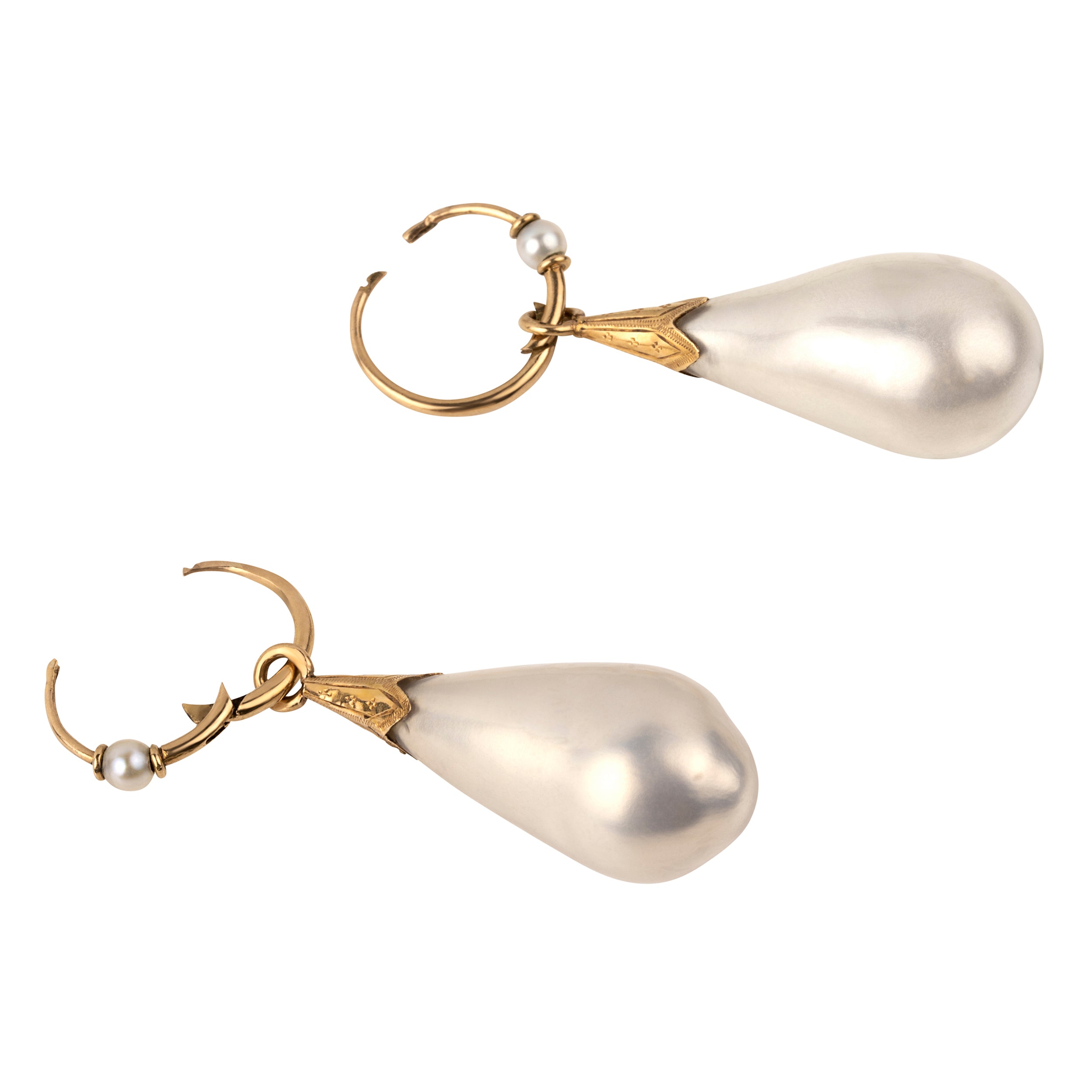 In the 18th century, glass pearl earrings were a popular alternative to natural pearls, and they commanded great prices. These imitation pearls were made by coating the interior of blown glass with a pearlescent ‘nacre’ derived from fish scales and gelatin. Earrings of the time reflected the Baroque and Rococo fashion, favoring long, dangling styles like girandole and pendant earrings. They were a staple in 18th-century jewelry, but their delicate nature makes them very rare today. England. Circa 1870