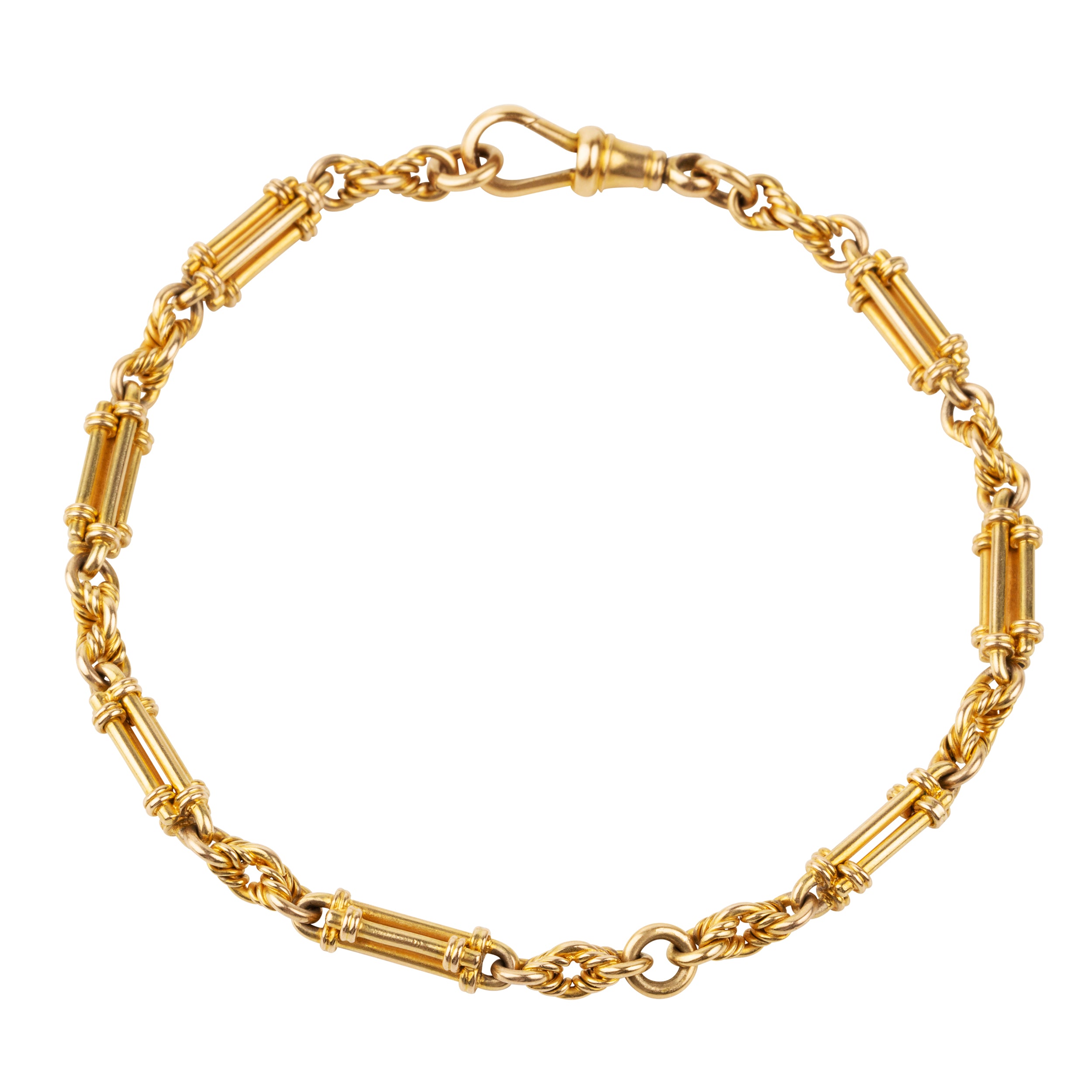 A petite but intricate watch chain bracelet. A deep yellow 18k gold is formed in bar and twisted links. Originally part of a 19th-century watch chain, this piece is robust enough to wear every day and be an addition to a bracelet stack or worn alone.While the bracelet is not bulky, there is still a nice weight to it as each element is solid. There is one bar element that has been lost with time, pictured.England. Circa 1870.