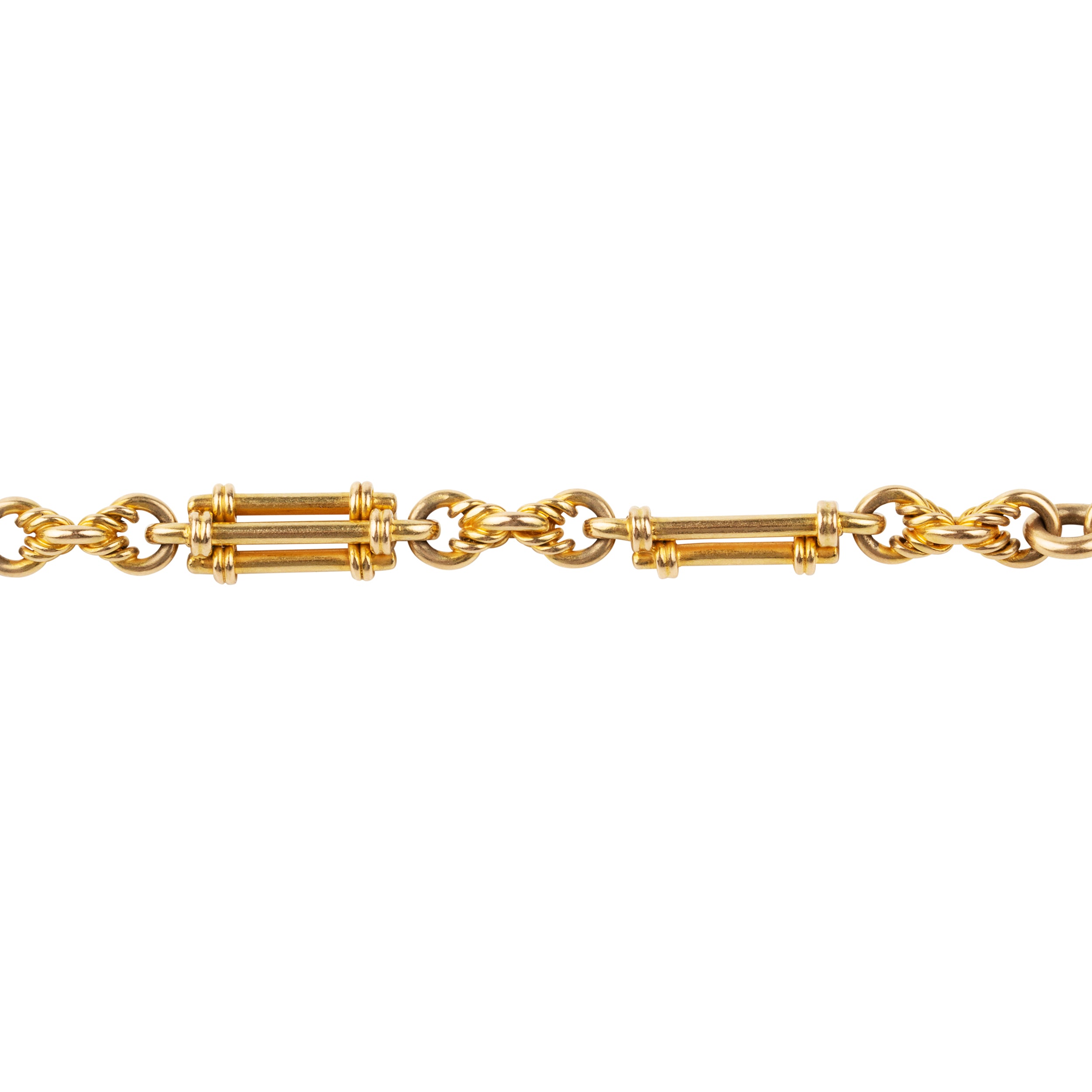 A petite but intricate watch chain bracelet. A deep yellow 18k gold is formed in bar and twisted links. Originally part of a 19th-century watch chain, this piece is robust enough to wear every day and be an addition to a bracelet stack or worn alone.While the bracelet is not bulky, there is still a nice weight to it as each element is solid. There is one bar element that has been lost with time, pictured.England. Circa 1870.