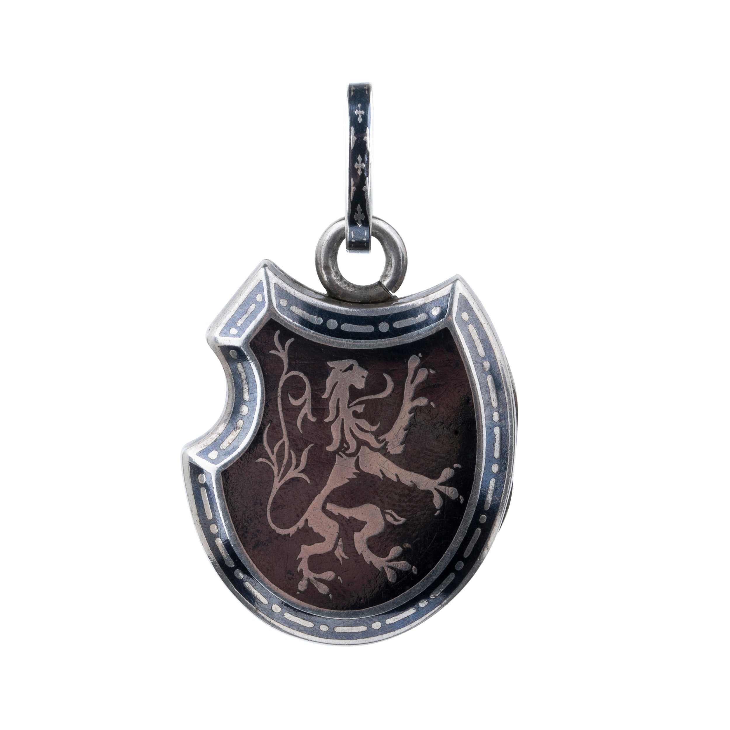 Victorian era niello locket in silver, rampant lion with fleur-de-lis details. Neillo is a process similar to enameling where a black alloy is inlayed into the silver. It opens to reveal two compartments for photographs or keepsakes. French. Circa 1890.