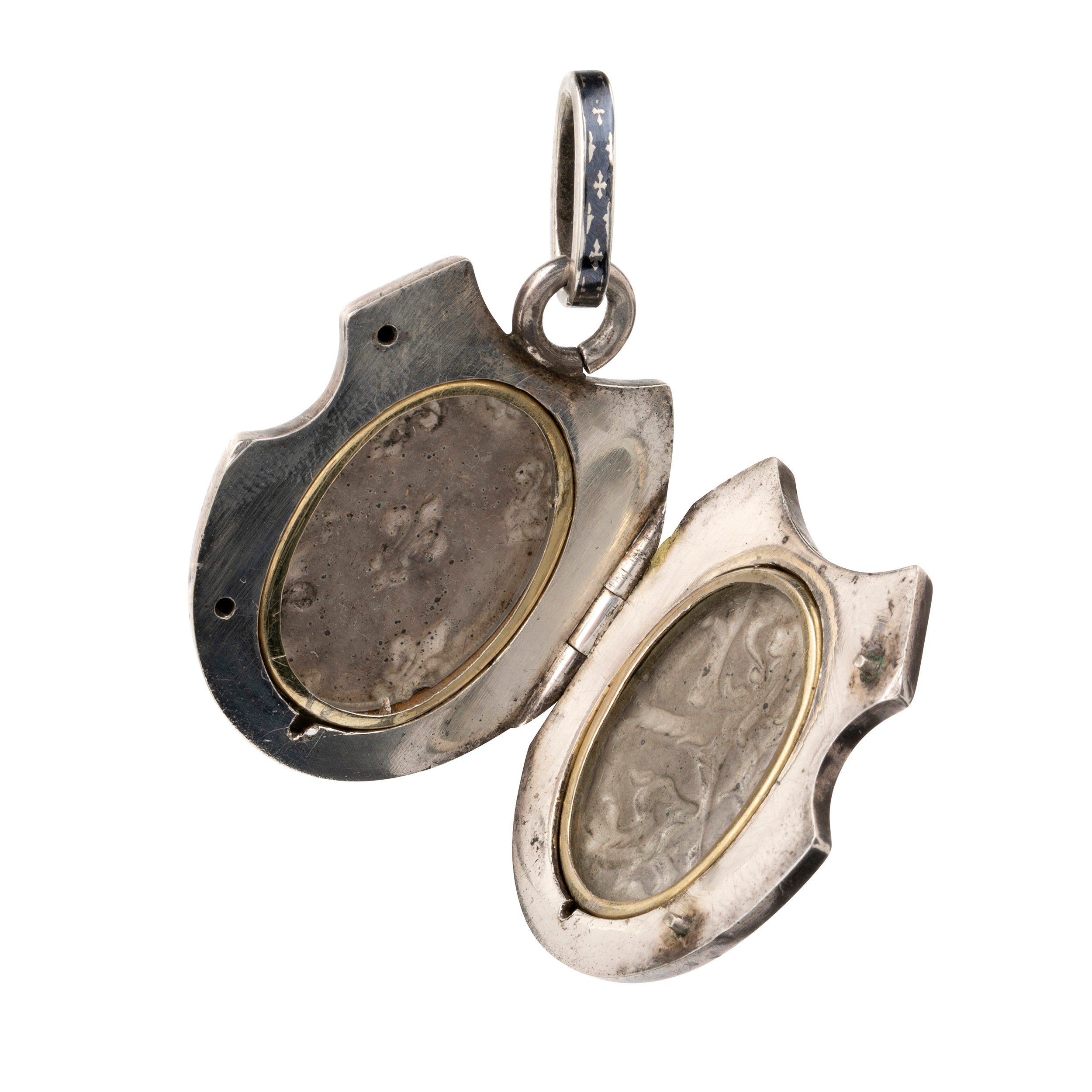 Victorian era niello locket in silver, rampant lion with fleur-de-lis details. Neillo is a process similar to enameling where a black alloy is inlayed into the silver. It opens to reveal two compartments for photographs or keepsakes. French. Circa 1890.