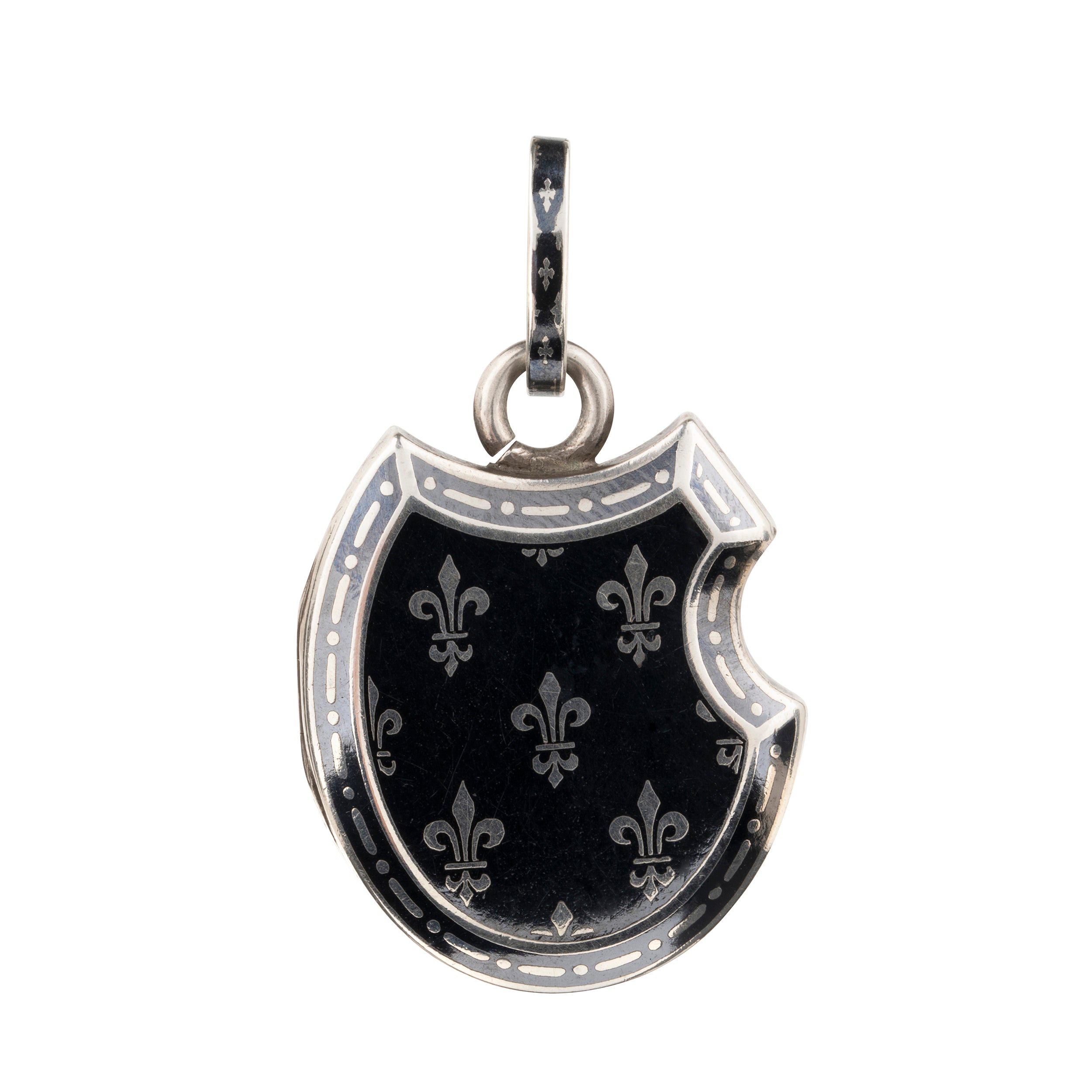 Victorian era niello locket in silver, rampant lion with fleur-de-lis details. Neillo is a process similar to enameling where a black alloy is inlayed into the silver. It opens to reveal two compartments for photographs or keepsakes. French. Circa 1890.