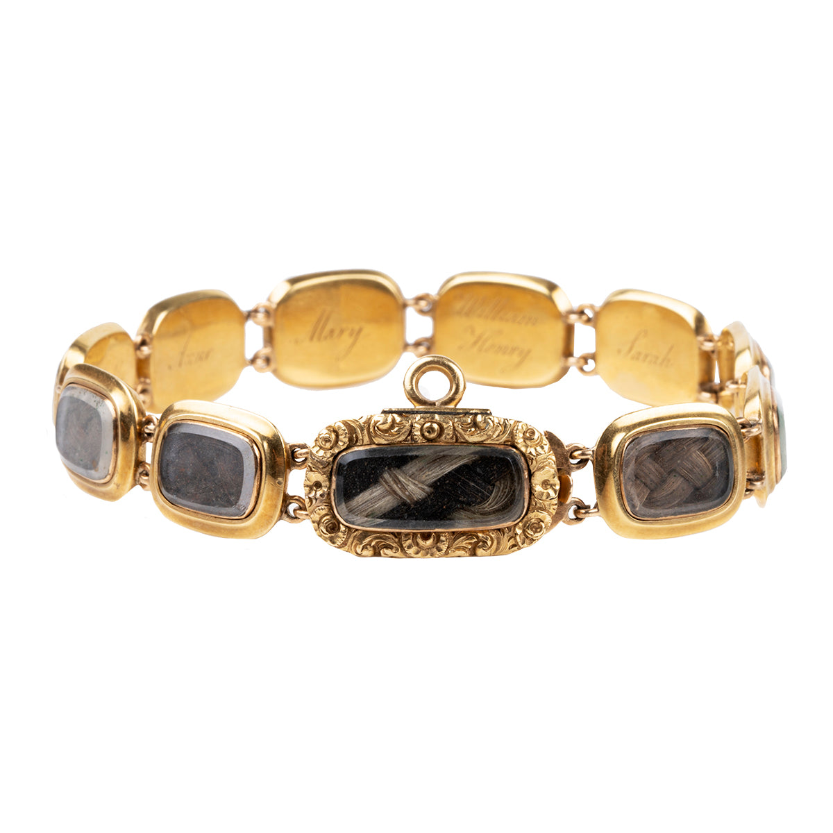 Georgian-era commemorative locket bracelet in gold. The bracelet has eleven glazed compartments with well preserved braided hair and beautiful hand-engraved names. The engravings list " WN & JN, Catherine, Jane, Isabella, Anne, Mary, William Henry, Sarah, Frances, George Stewart, Caroline". Likely including all of the children of the original owner. English in origin. Circa 1820.