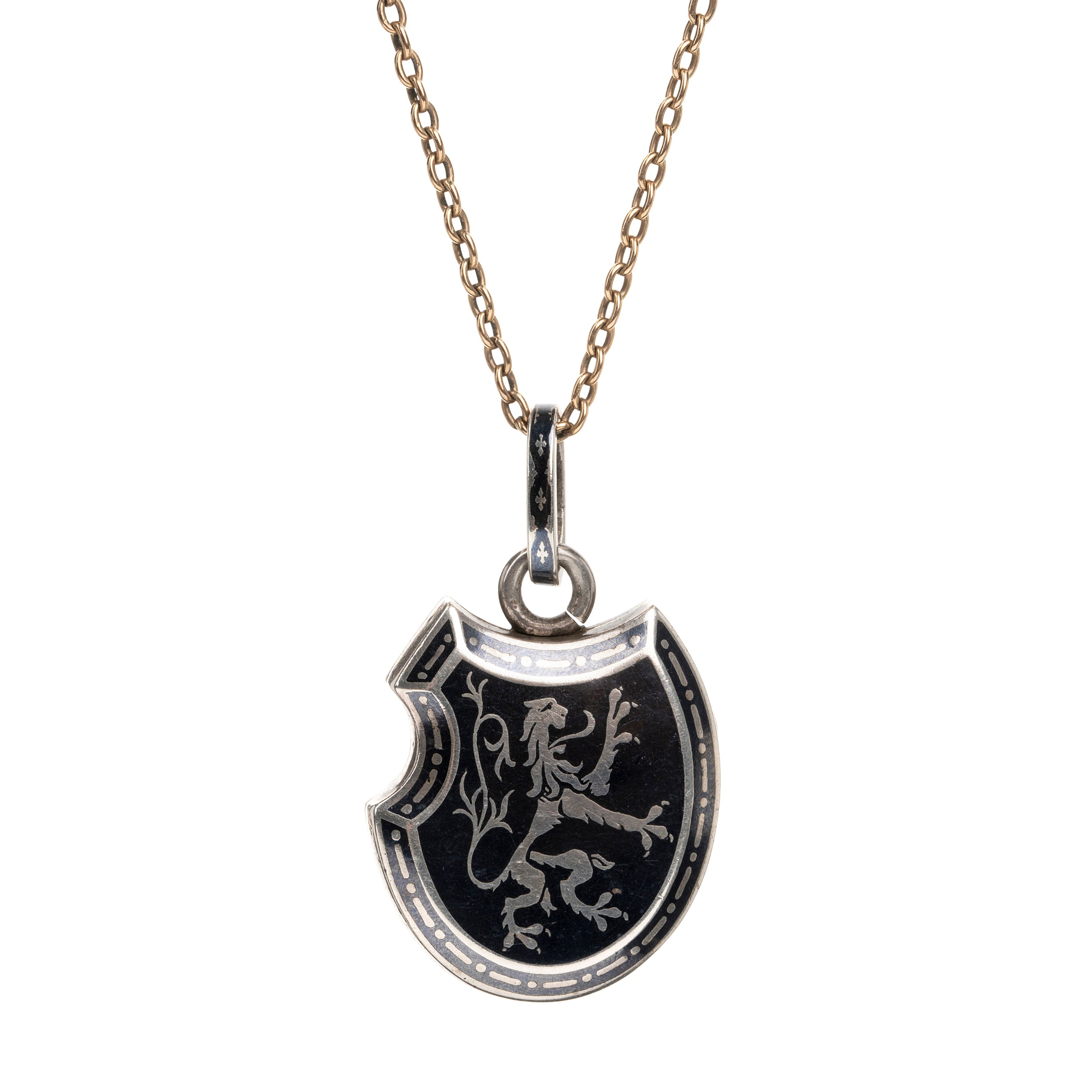Victorian era niello locket in silver, rampant lion with fleur-de-lis details. Neillo is a process similar to enameling where a black alloy is inlayed into the silver. It opens to reveal two compartments for photographs or keepsakes. French. Circa 1890.