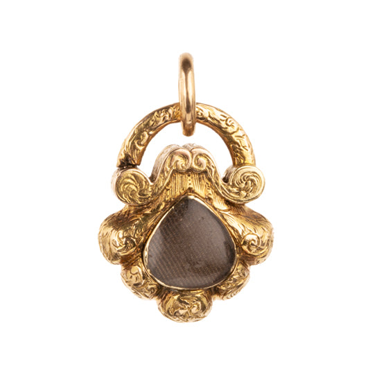 Early Victorian era turquoise padlock locket in 15k gold. It is in the form of a shell with Persian turquoise and a glazed compartment. English in origin. Circa 1840. Hanging on an antique 15k gold turquoise beaded ball chain.