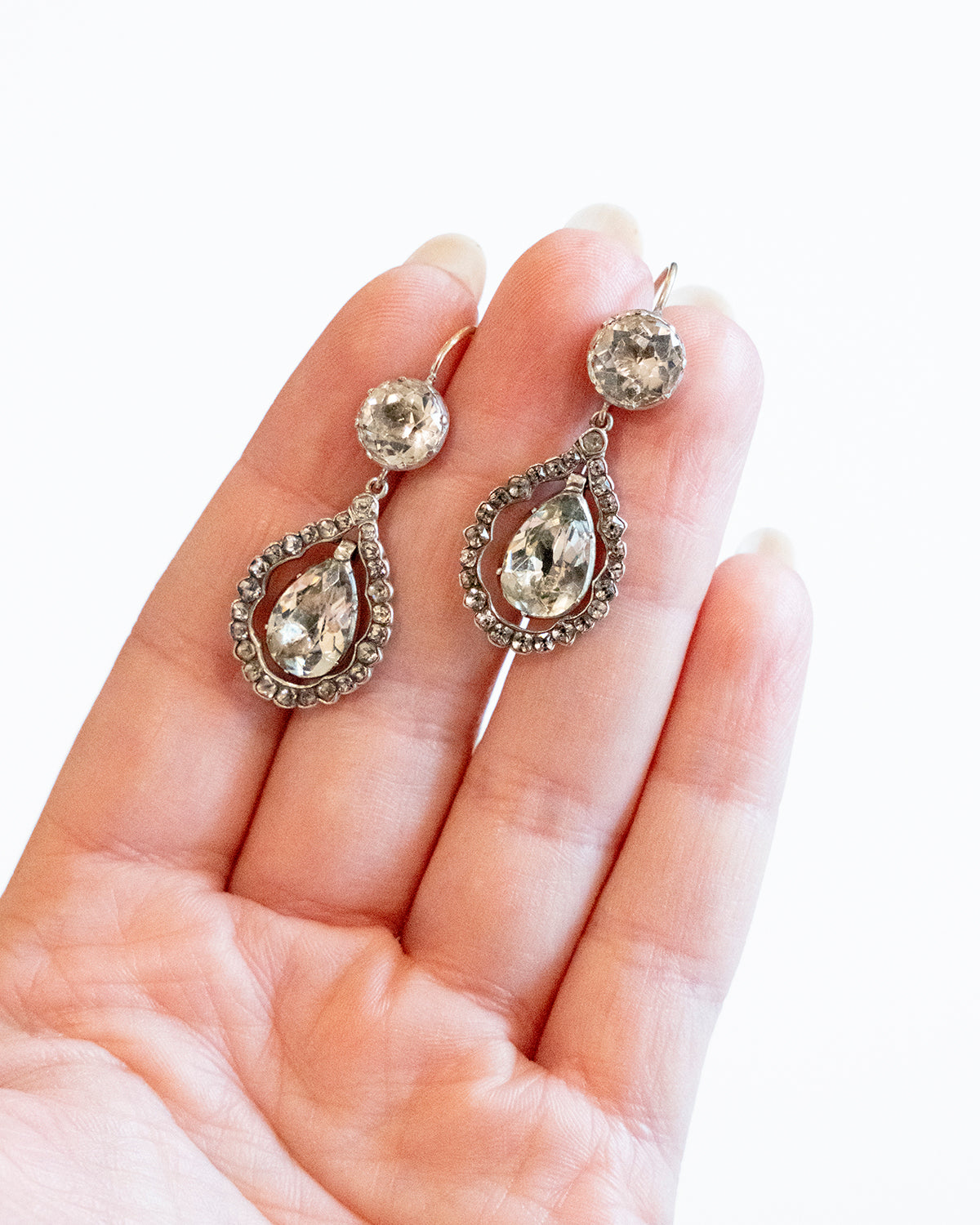 Paste earring being held on a hand for scale reference.