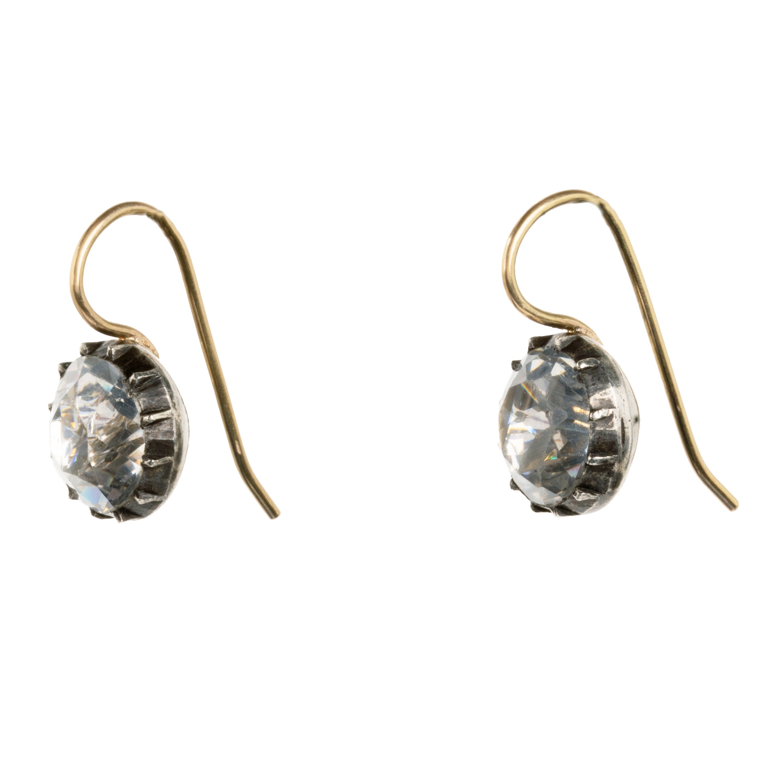 Georgian era white paste earrings, in silver and gold. Round shaped paste stones are set in foiled back silver settings on 18k gold wires. What were once beautiful Georgian era buttons or cufflinks are now perfect everyday earrings.English in origin. Circa 1820. Side view.