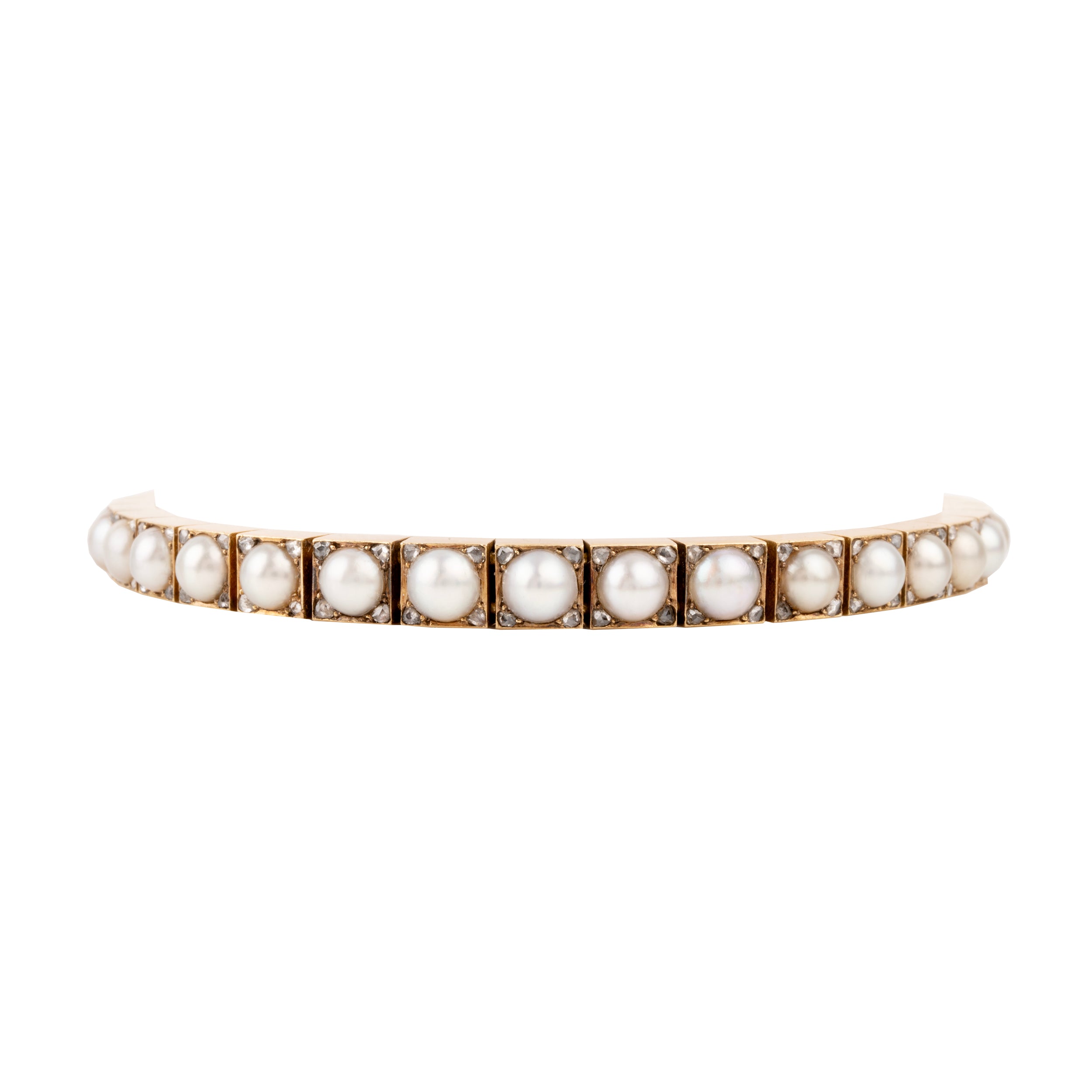 Edwardian era pearl and diamond line bracelet. White split pearls are set in 18k yellow gold. Each pearl is pointed with four rose cut diamonds in square settings. England, circa 1910.