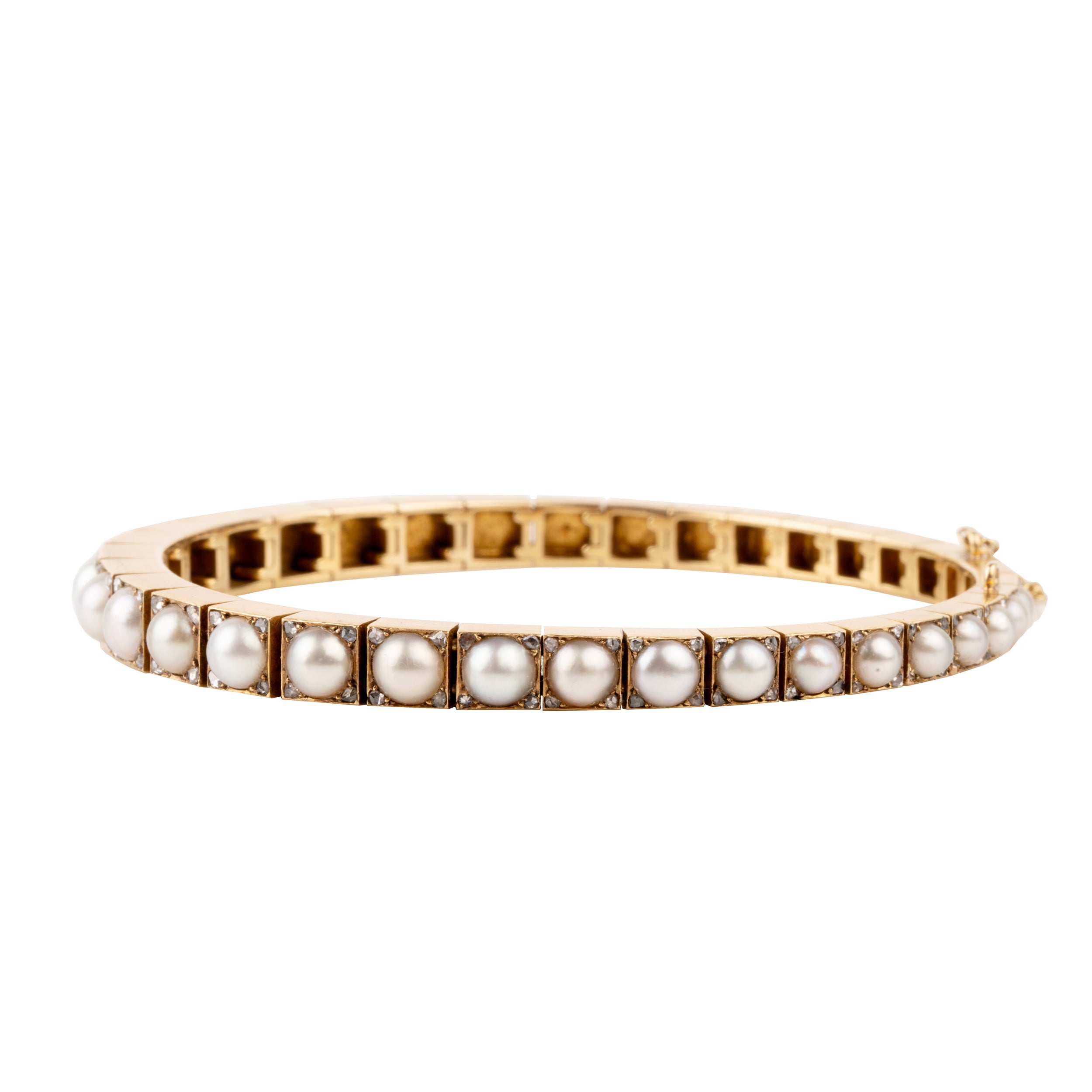 Edwardian era pearl and diamond line bracelet. White split pearls are set in 18k yellow gold. Each pearl is pointed with four rose cut diamonds in square settings. England, circa 1910. side view.