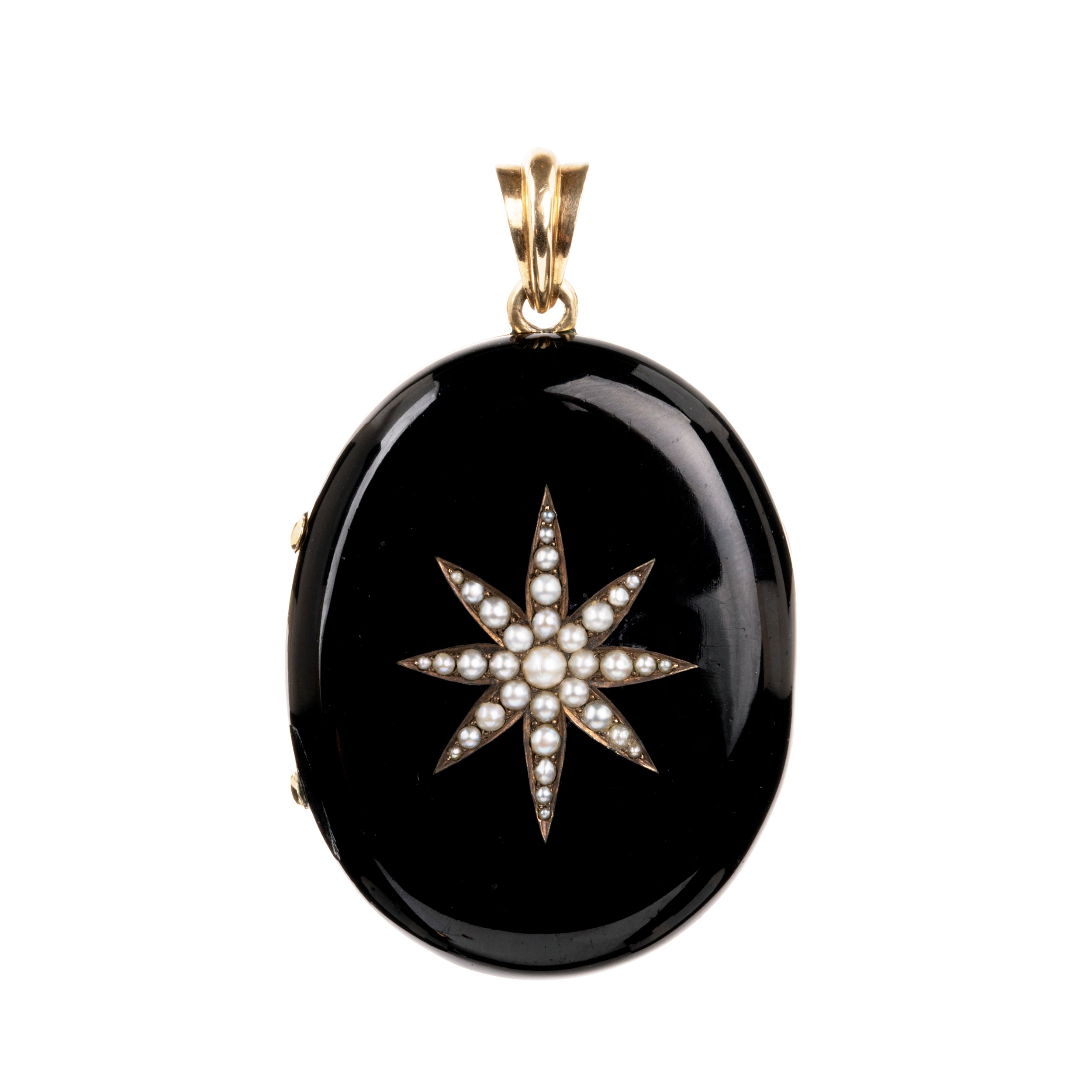 A bold black enamel locket with a pearl starburst motif. The locket is crafted in 18k gold. It opens to reveal two compartments for photographs or keepsakes. England, circa 1870.