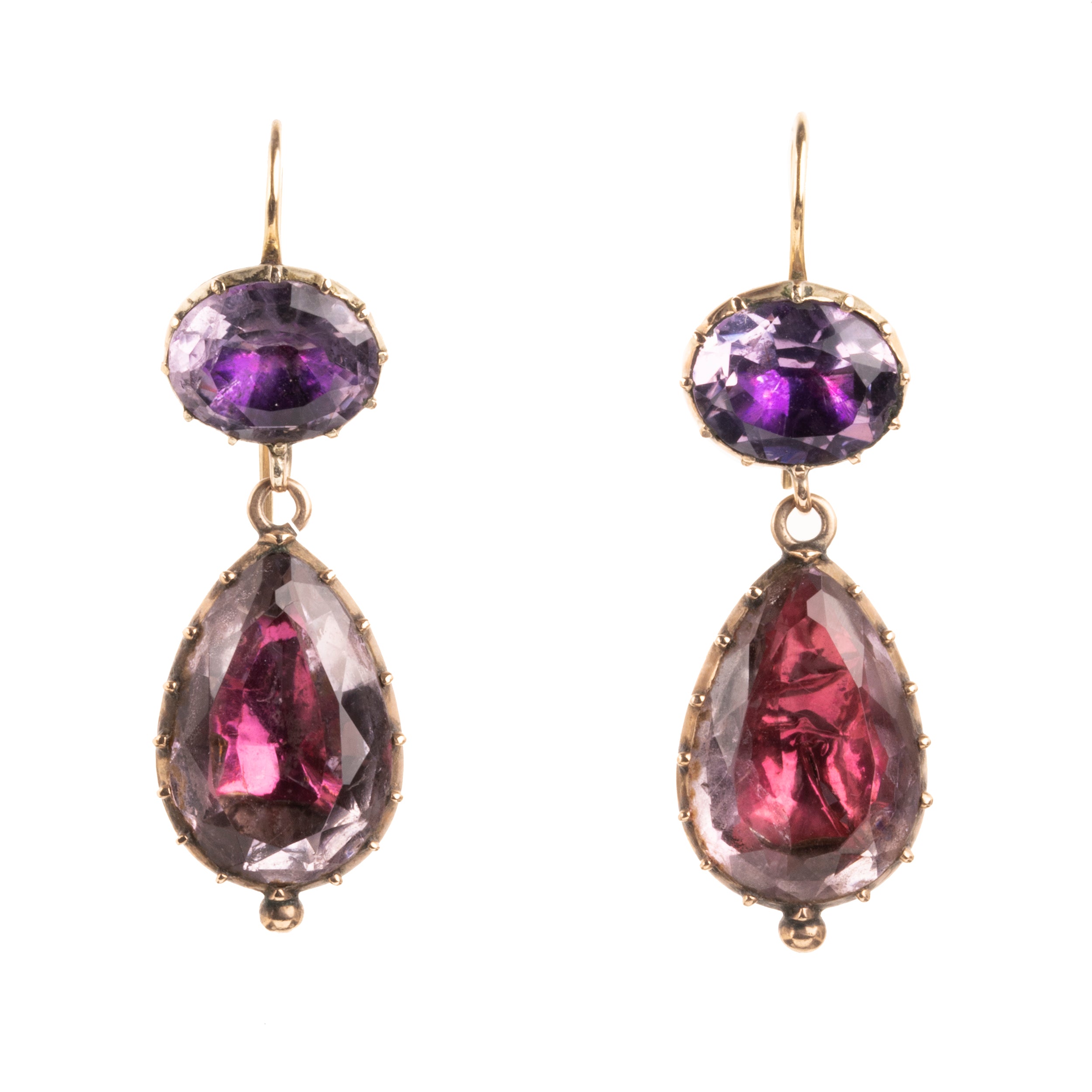 Lovely early 19th century earrings set in 15k gold. Cushion and pear shaped amethyst stones set in closed-back collet settings. The stones are a pale purple, with varied shades of purple and pink coming from the foil behind the stones. The coloring is very unique. English in origin. Circa 1800. Front view.