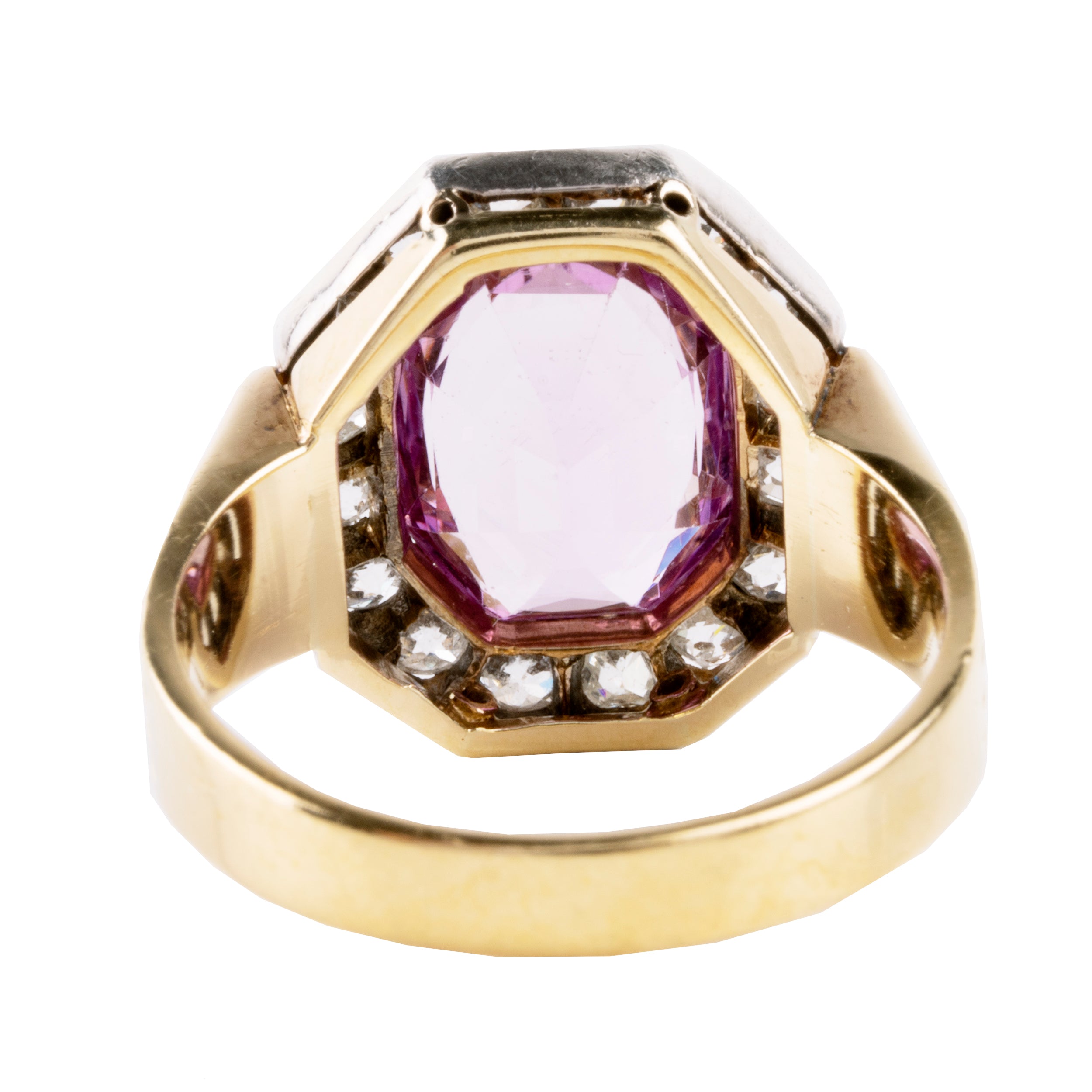 Striking ring with a large, vibrant pink precious topaz stone. It has very crisp clarity and rich color. The photographs do not capture the depth of color. There are sixteen mixed-cut antique diamonds surrounding the primary stone. Old Mine and old European cuts are set in platinum, while the rest of the ring is in 18k gold. England, circa 1900. backside view.