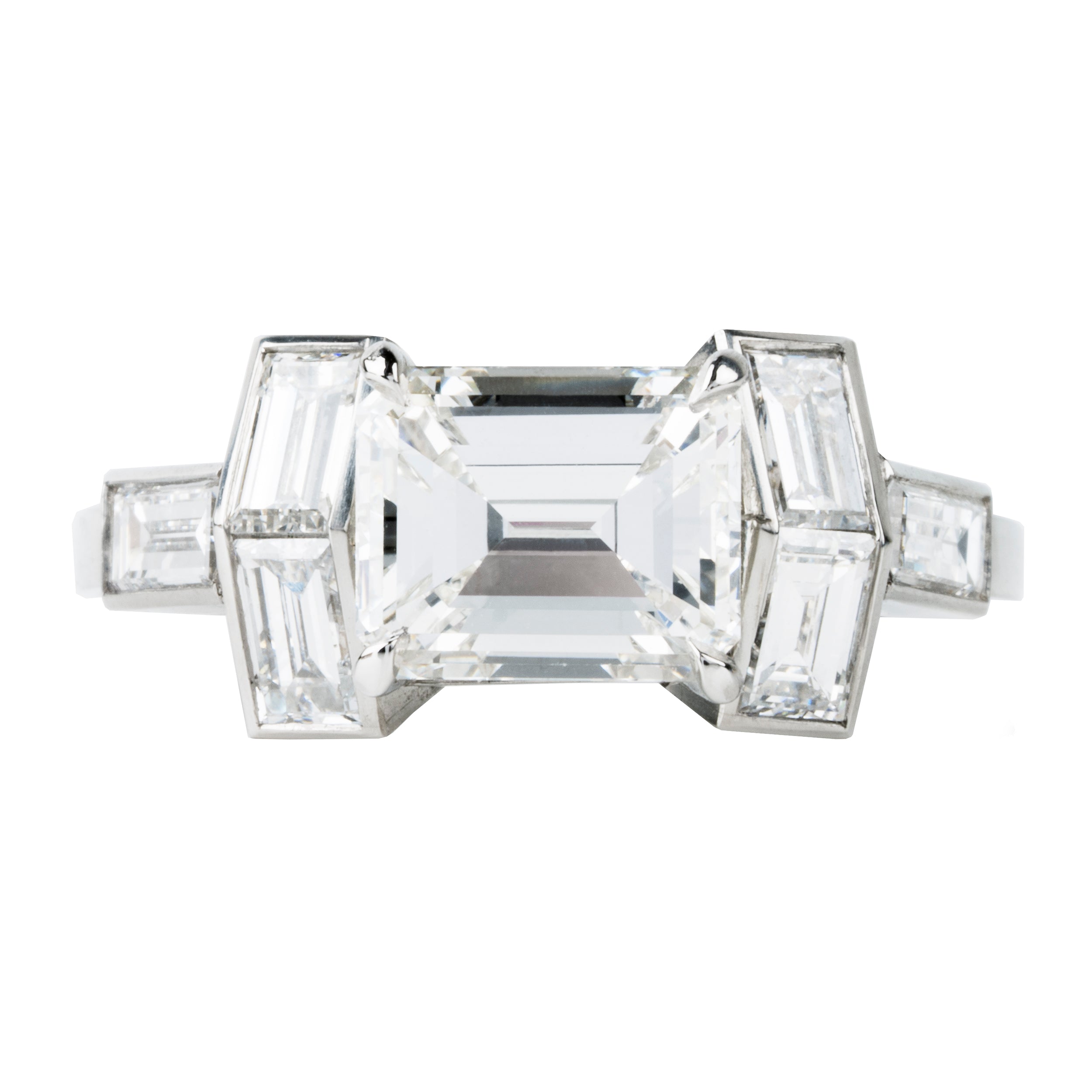 A contemporary design constructed a seven-stone ring with classical techniques. Six baguette diamonds surround an emerald cut diamond. This ring features a GIA-certified emerald cut diamond, 2.01 carats, H color, and VS1 clarity. There are six vintage baguette diamonds, approximately 1.12 carats in total diamond weight, H color, and VS2 clarity. Handcrafted in platinum.