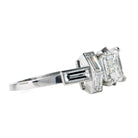 A contemporary design constructed a seven-stone ring with classical techniques. Six baguette diamonds surround an emerald cut diamond. This ring features a GIA-certified emerald cut diamond, 2.01 carats, H color, and VS1 clarity. There are six vintage baguette diamonds, approximately 1.12 carats in total diamond weight, H color, and VS2 clarity. Handcrafted in platinum.