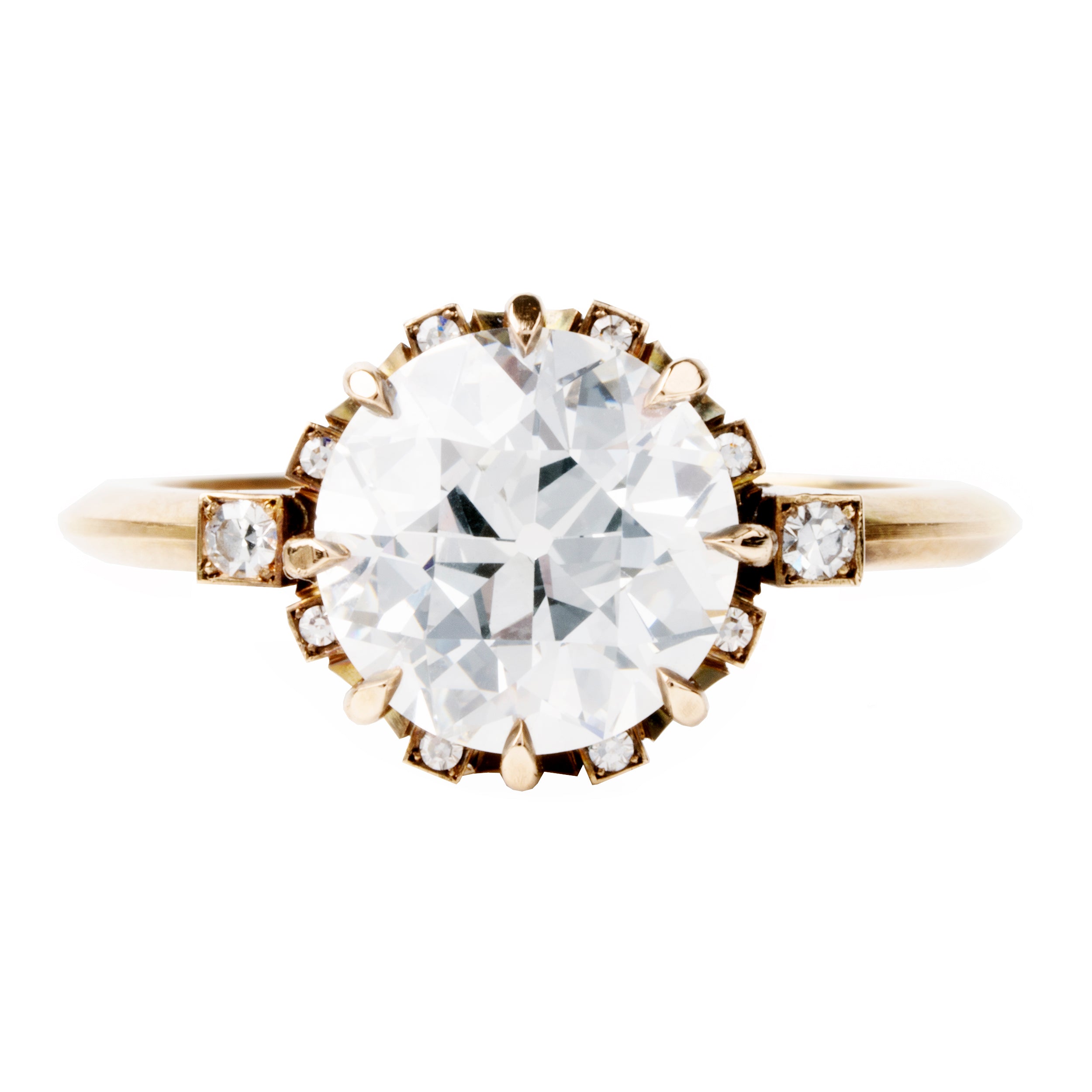 A solitaire ring with a round old European cut diamond centerpiece, surrounded by smaller single-cut diamonds set around the band.