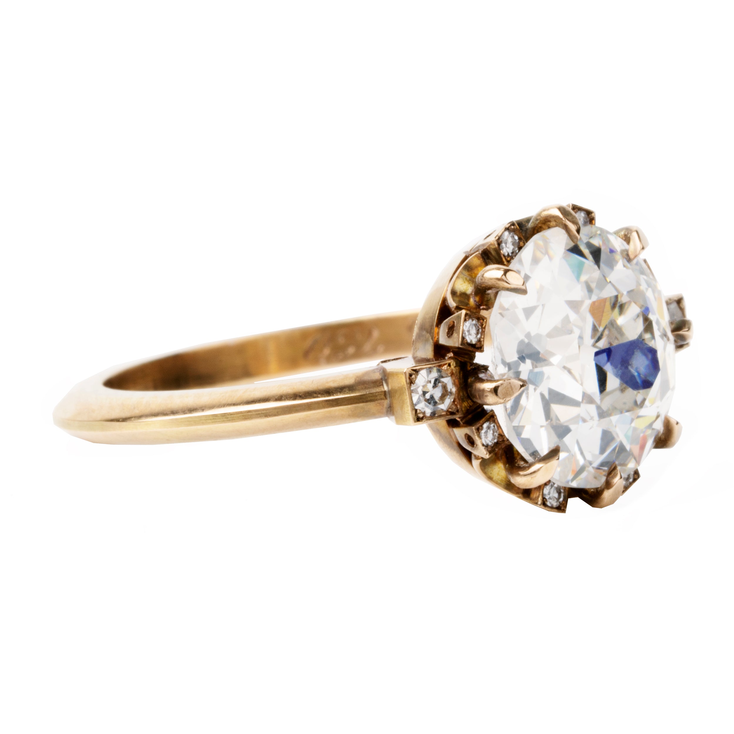 A solitaire ring with a round old European cut diamond centerpiece, surrounded by smaller single-cut diamonds set around the band.