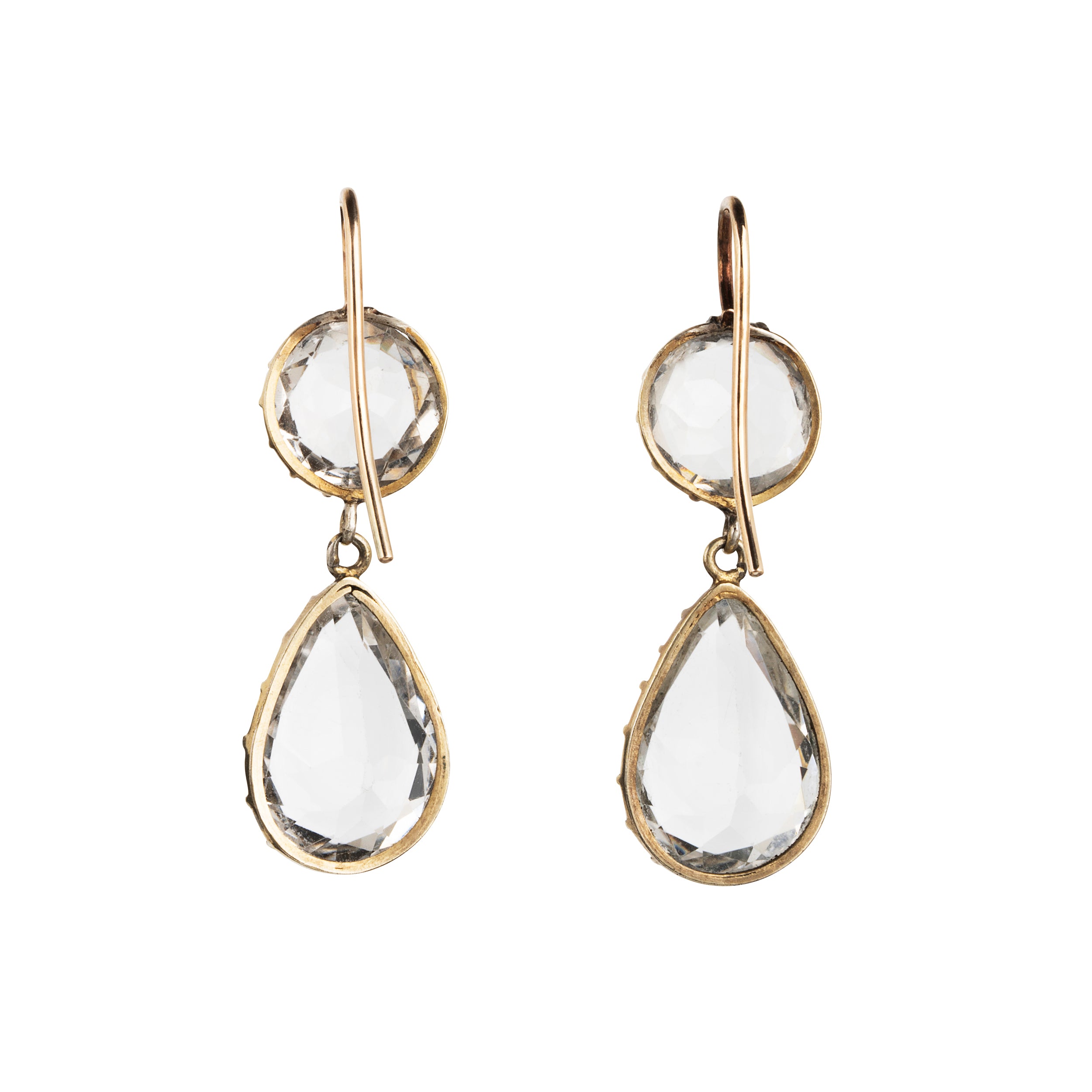 Victorian era rock crystal tear drop earrings. The stones are set in open back cut-down silver gilt settings. England. Circa 1880.
