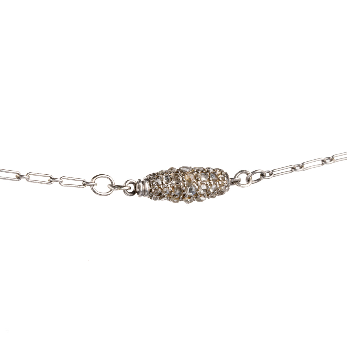 A rare Georgian-era diamond ball pendant is hanging on an early 20th century French platinum chain. Rose-cut diamonds are intricately pavé set in silver, gold, and platinum. The chain has French hallmarks and The ball is English in origin. Circa 1820. Close up front view. detail of the diamond clasp.