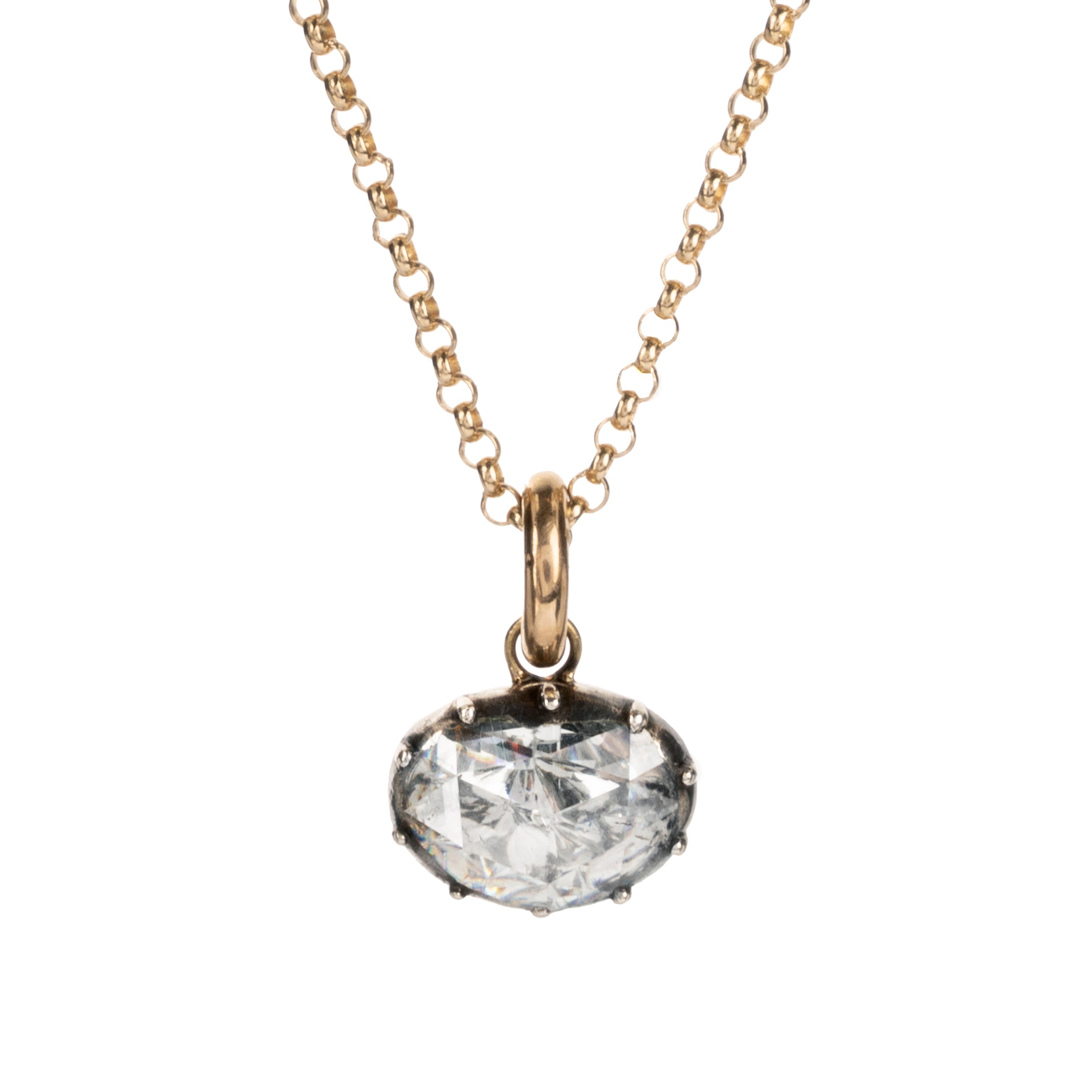 Georgian era rose cut diamond pendant necklace. The bright rose cut diamond is a subtle heart-shape, set in a foiled closed-back setting. Originally part of a larger piece of jewelry, it was later converted into a simple charm pendant. The diamond weighs approximately .95 carats. The diamond is quite flat and faces- up like a two-carat stone. Found in Paris. Circa 1820. Front view of the necklace. The diamond is hanging from a delicate gold chain.