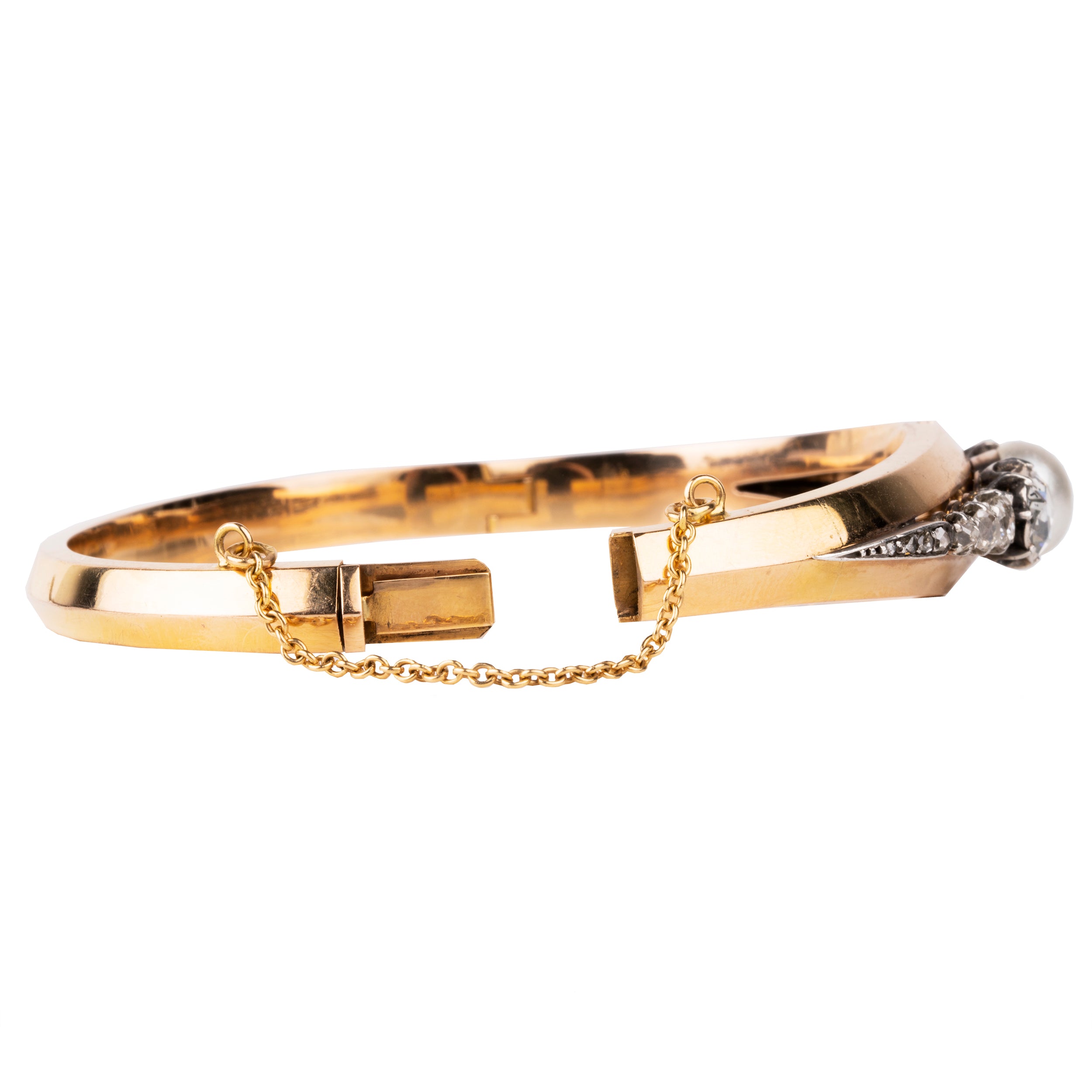 Approximately three carats of rose-cut diamonds are set in silver cut-away settings. The twenty diamonds flank a single natural pearl. The stones taper into a knife-edge detail in 18k rose gold. Continental Europe, circa 1860. Side view with safety chain.