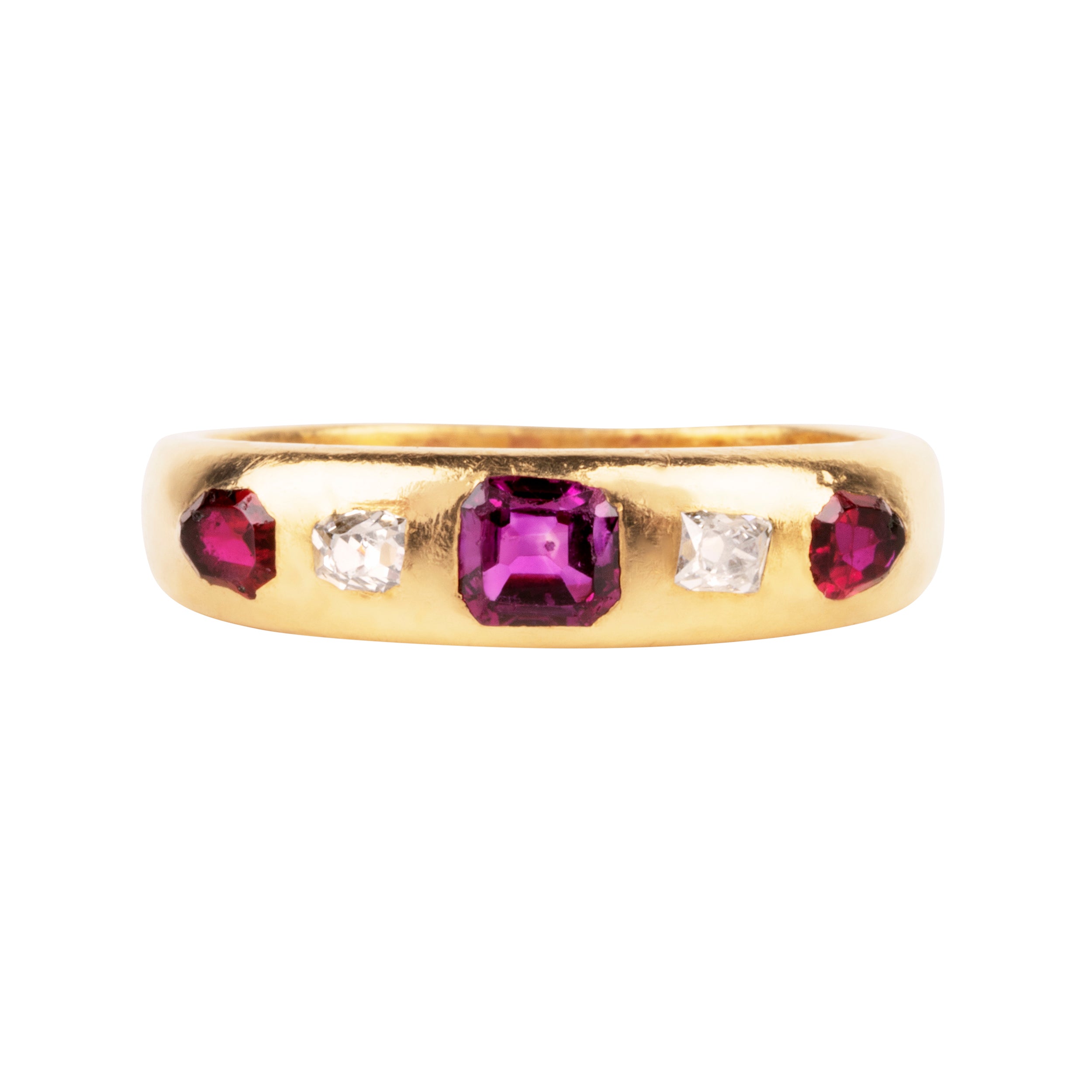 Victorian-era gypsy set ruby and diamond ring in 18k gold. A great mixture of high-crowned old mine cut diamonds with step-cut and shield-shaped rubies flush set. England, Circa 1880.