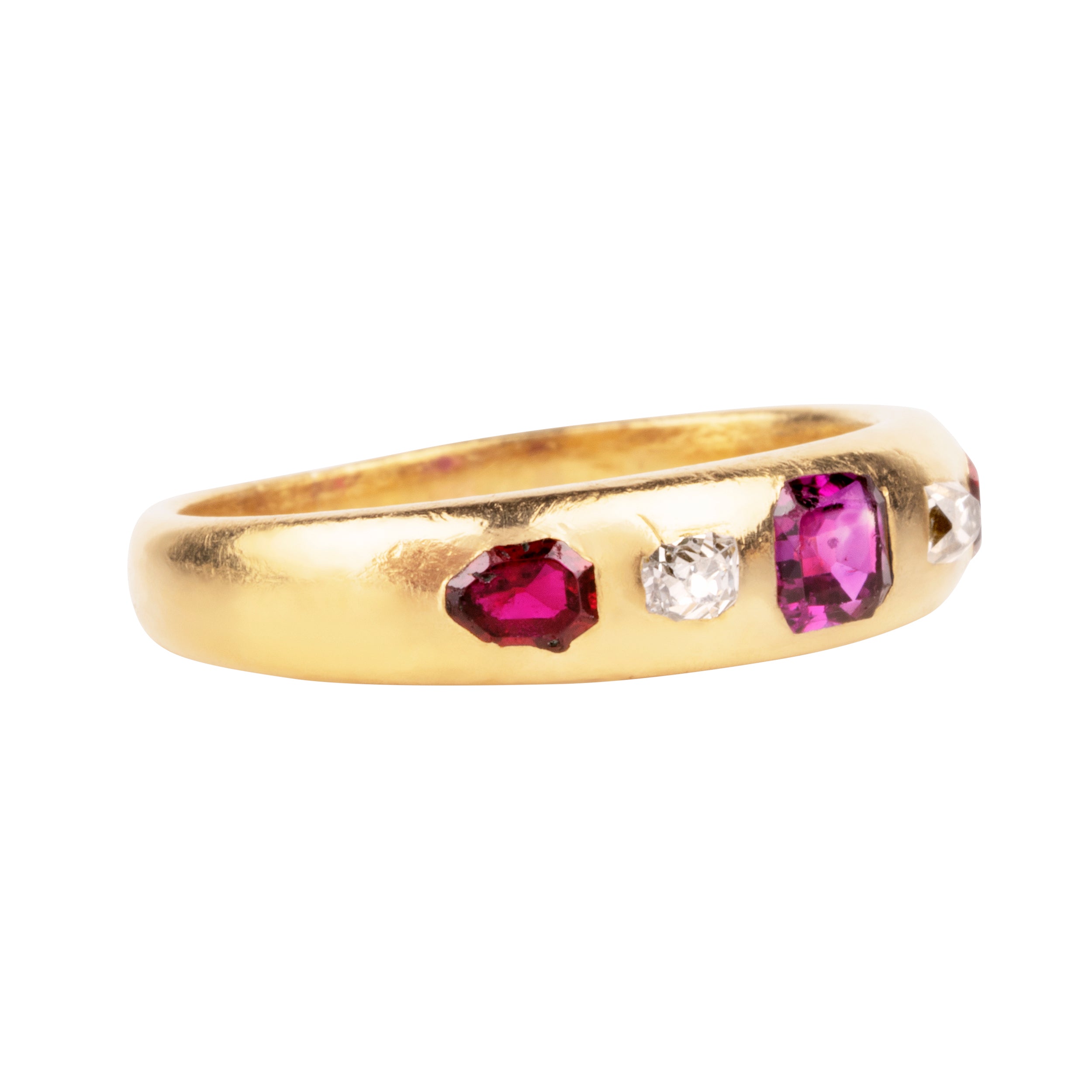 Victorian-era gypsy set ruby and diamond ring in 18k gold. A great mixture of high-crowned old mine cut diamonds with step-cut and shield-shaped rubies flush set. England, Circa 1880.