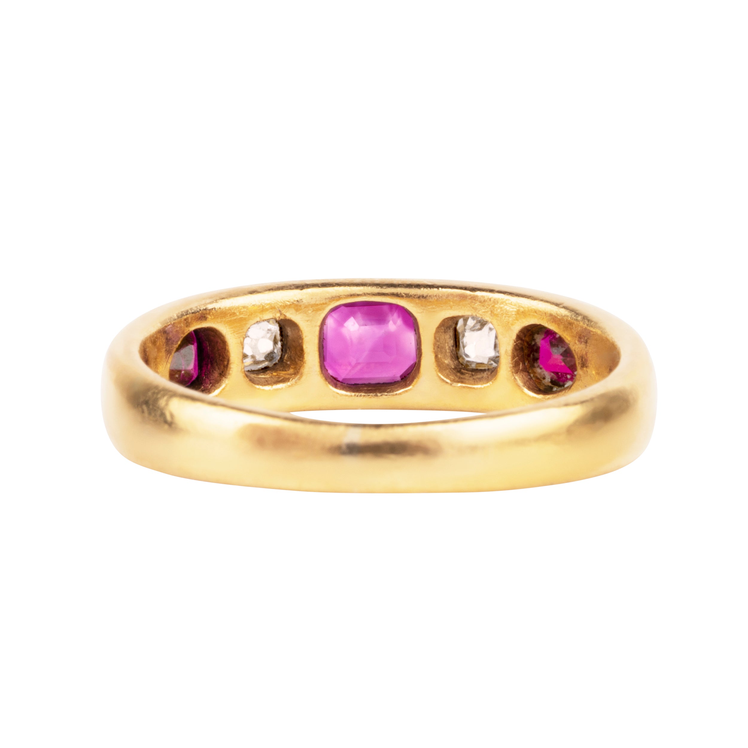 Victorian-era gypsy set ruby and diamond ring in 18k gold. A great mixture of high-crowned old mine cut diamonds with step-cut and shield-shaped rubies flush set. England, Circa 1880.
