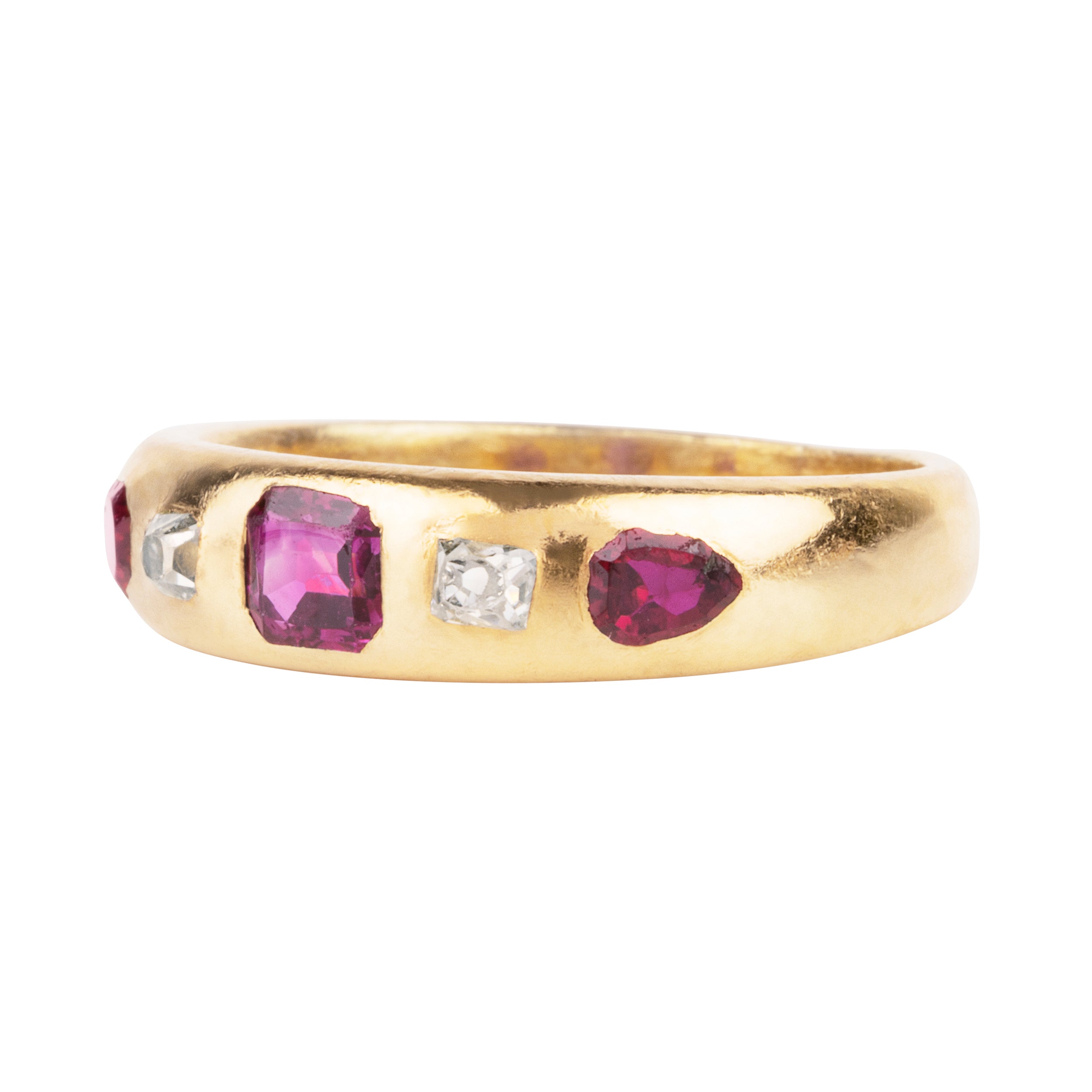 Victorian-era gypsy set ruby and diamond ring in 18k gold. A great mixture of high-crowned old mine cut diamonds with step-cut and shield-shaped rubies flush set. England, Circa 1880.